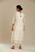 Off white cotton chanderi kurta set with tonal silk thread embroidery highlighted with sequins and beads.