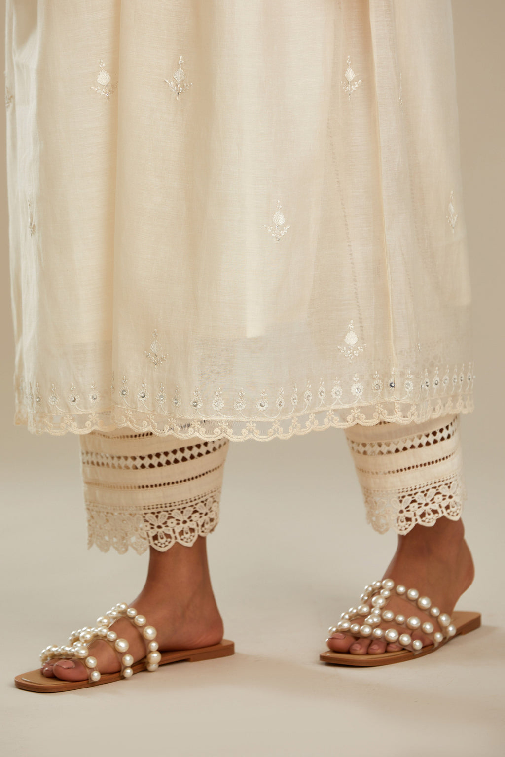 Off white cotton chanderi kurta set with tonal silk thread embroidery highlighted with sequins and beads.
