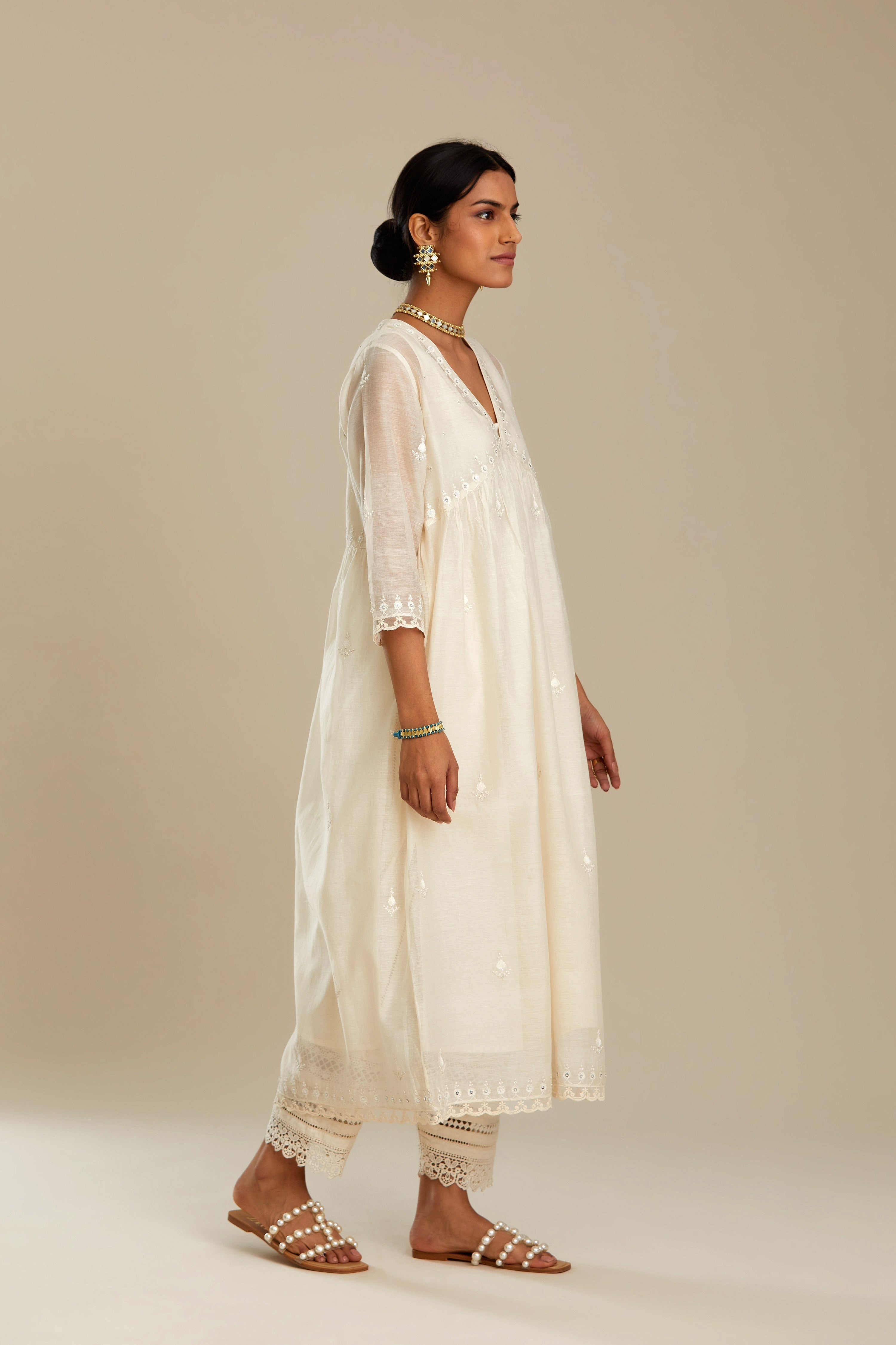 Off white cotton chanderi kurta set with tonal silk thread embroidery highlighted with sequins and beads.