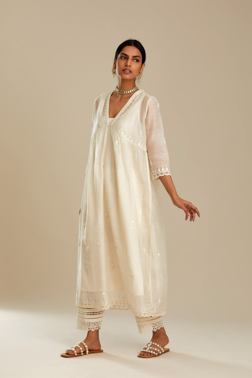 Off white cotton chanderi kurta set with tonal silk thread embroidery highlighted with sequins and beads.