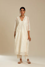 Off white cotton chanderi kurta set with tonal silk thread embroidery highlighted with sequins and beads.