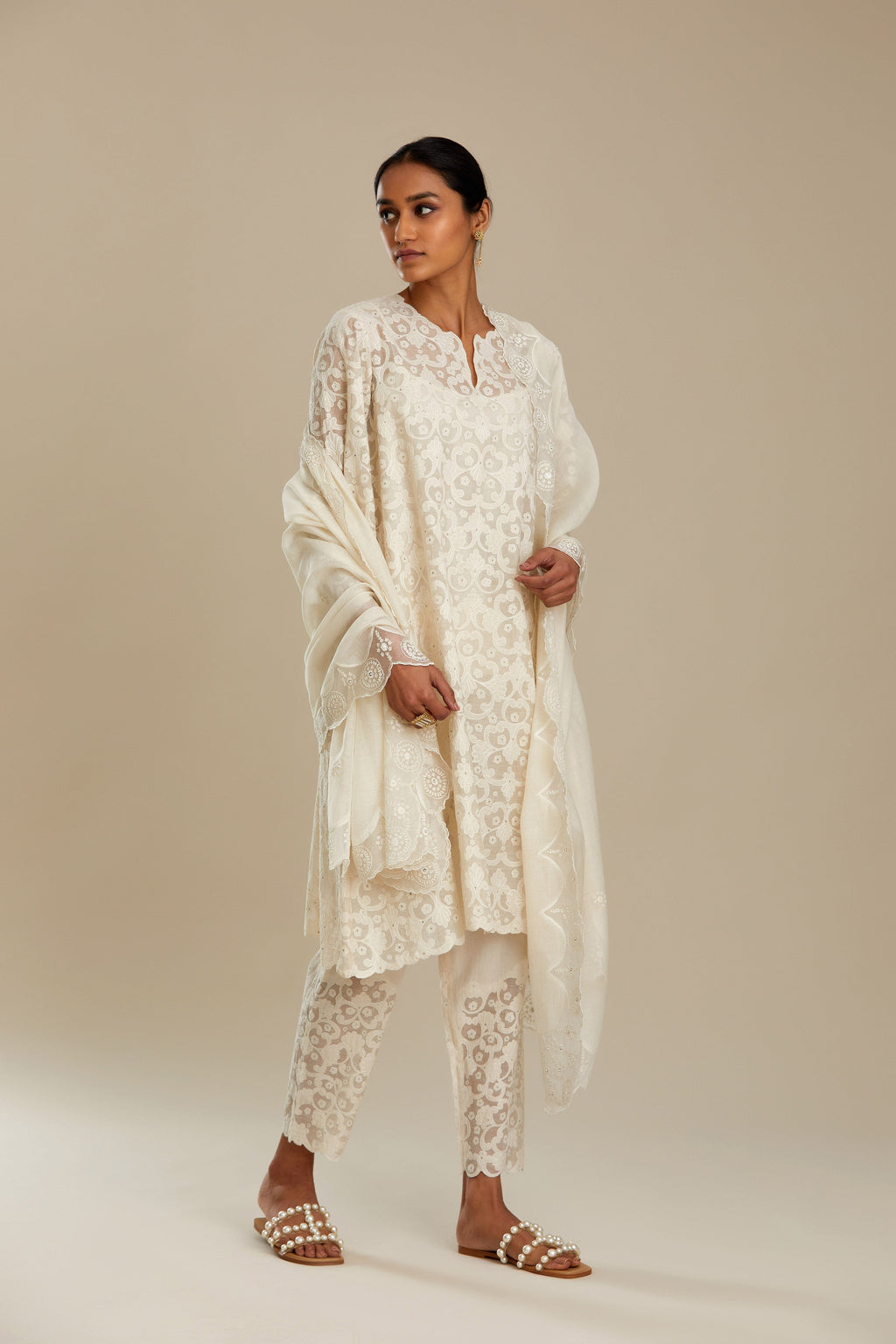Off white short easy fit, straight hem kurta set with all-over trellis jaal appliqué, highlighted with sequins.