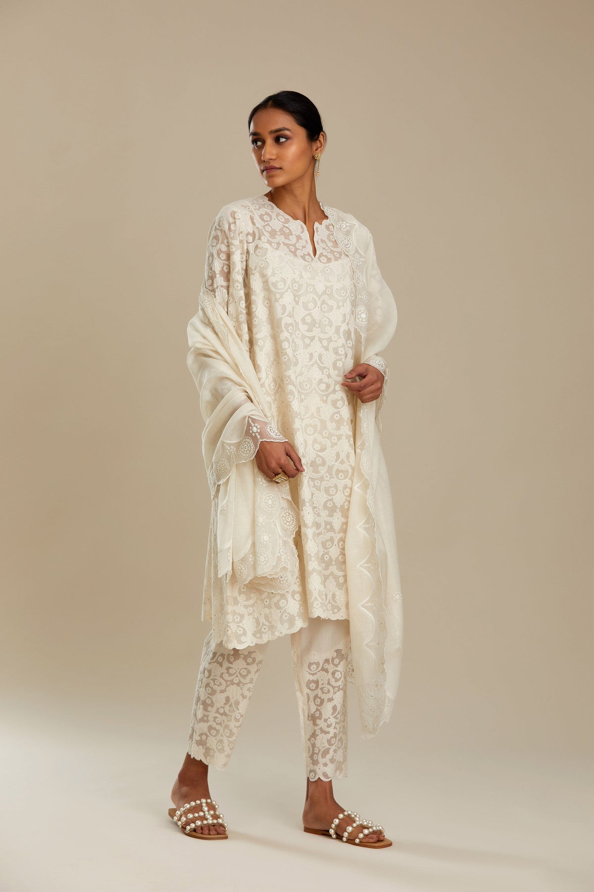Off white short easy fit, straight hem kurta set with all-over trellis jaal appliqué, highlighted with sequins.