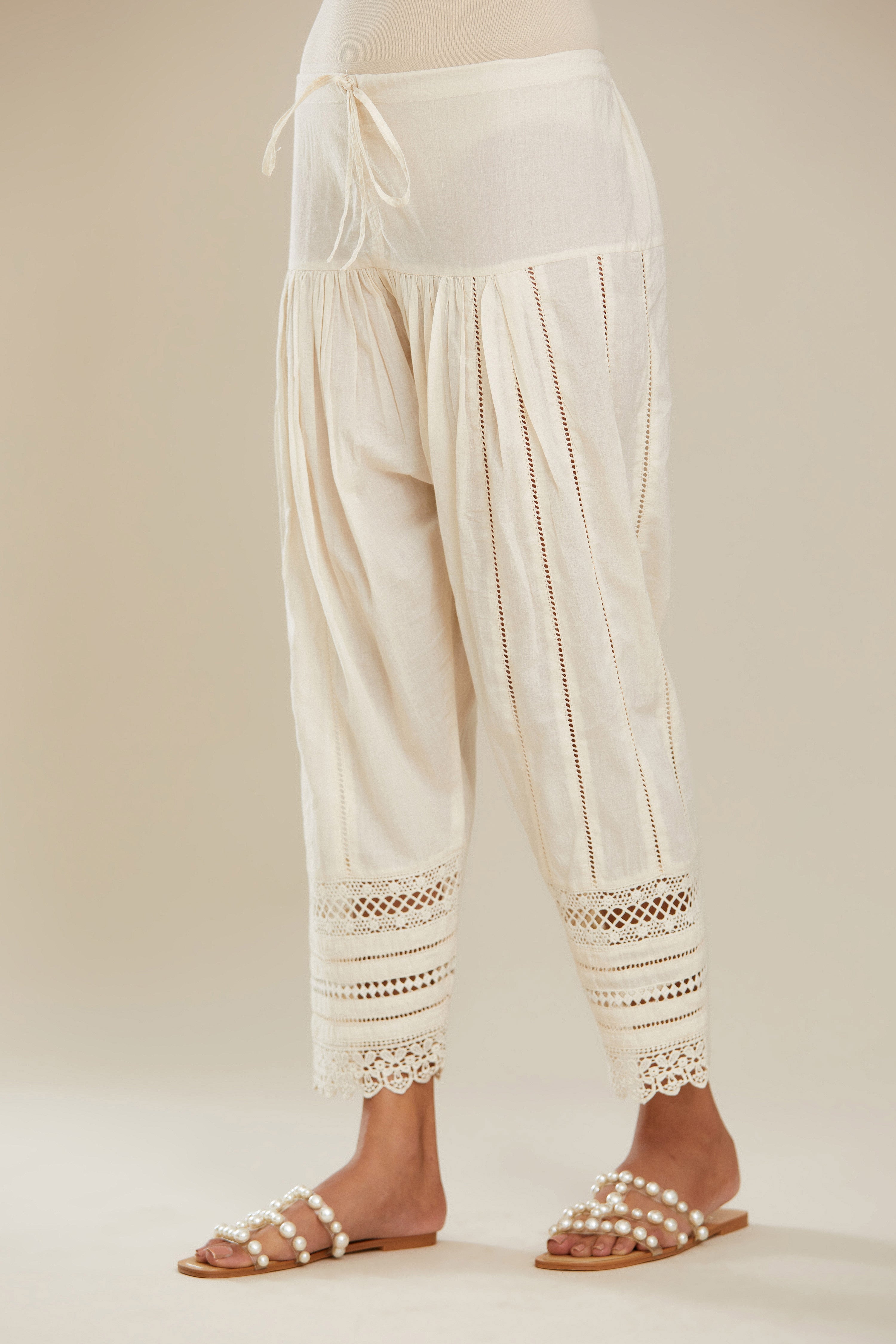 Off white cotton narrow salwar with assorted lace detailing. (Salwar)
