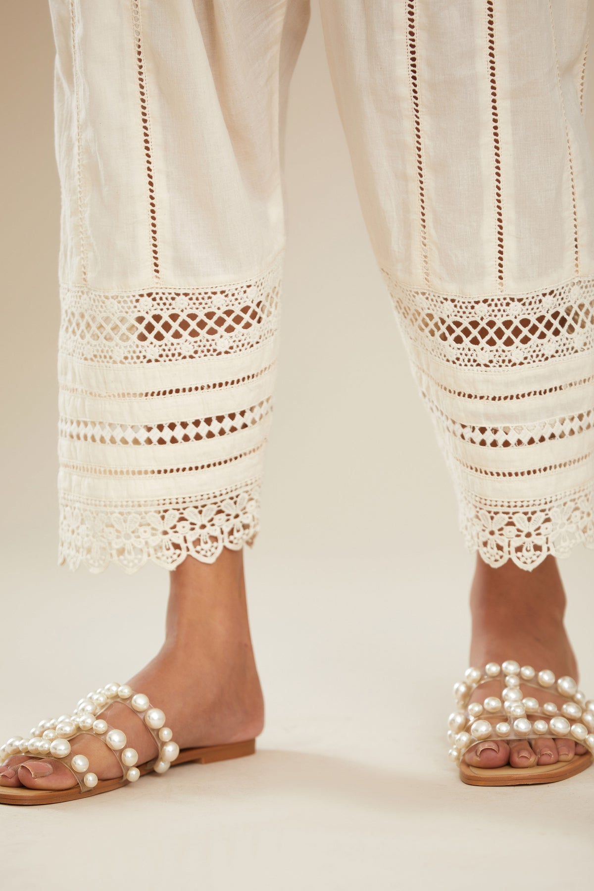 Off white cotton narrow salwar with assorted lace detailing. (Salwar)
