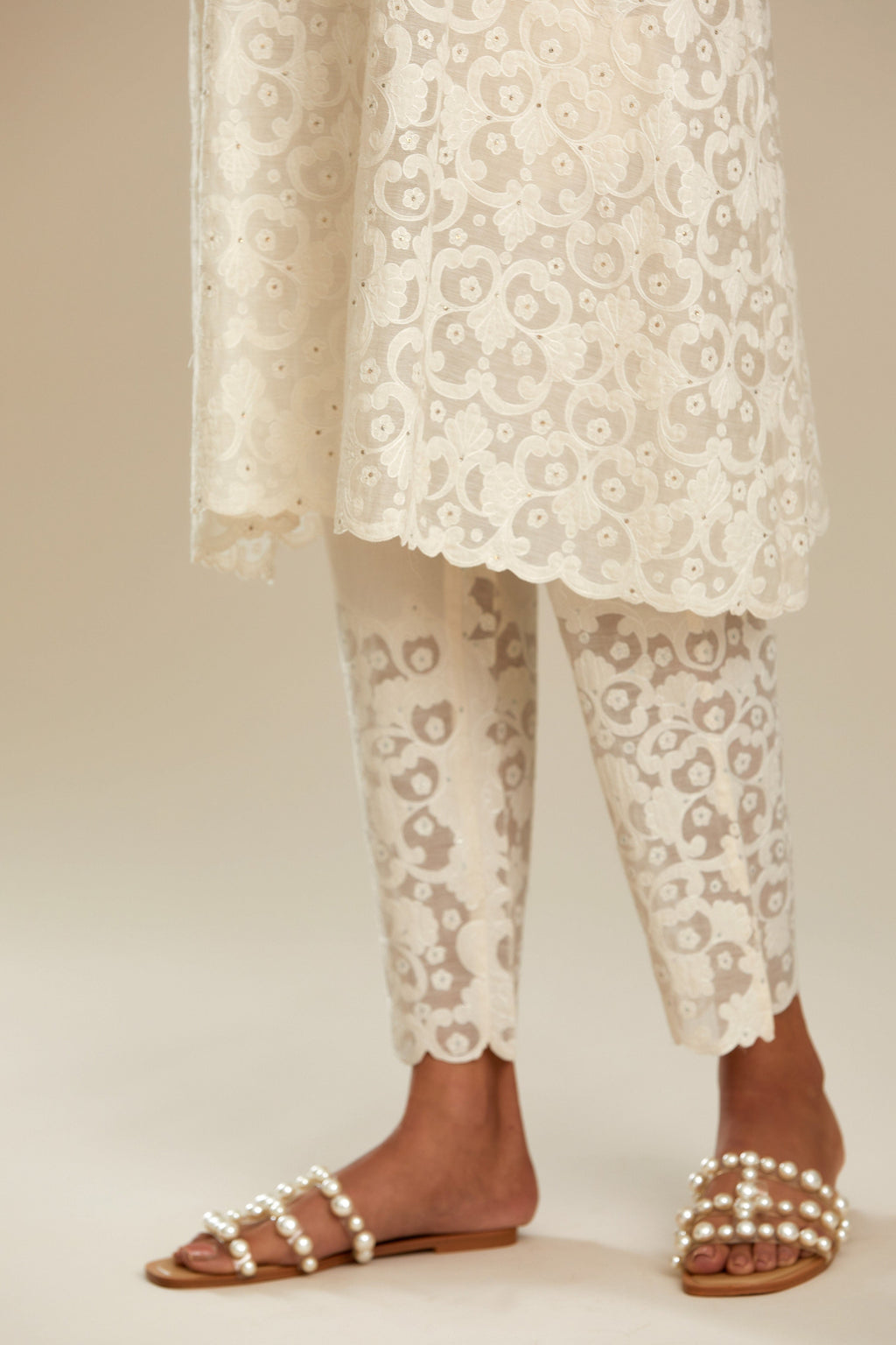 Off white short easy fit, straight hem kurta set with all-over trellis jaal appliqué, highlighted with sequins.