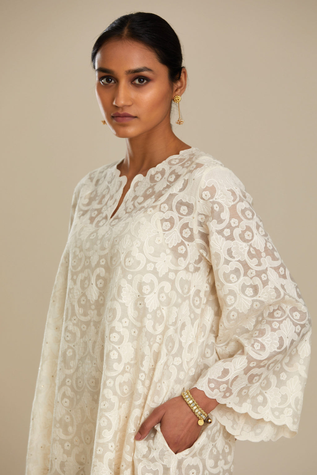 Off white short easy fit, straight hem kurta set with all-over trellis jaal appliqué, highlighted with sequins.
