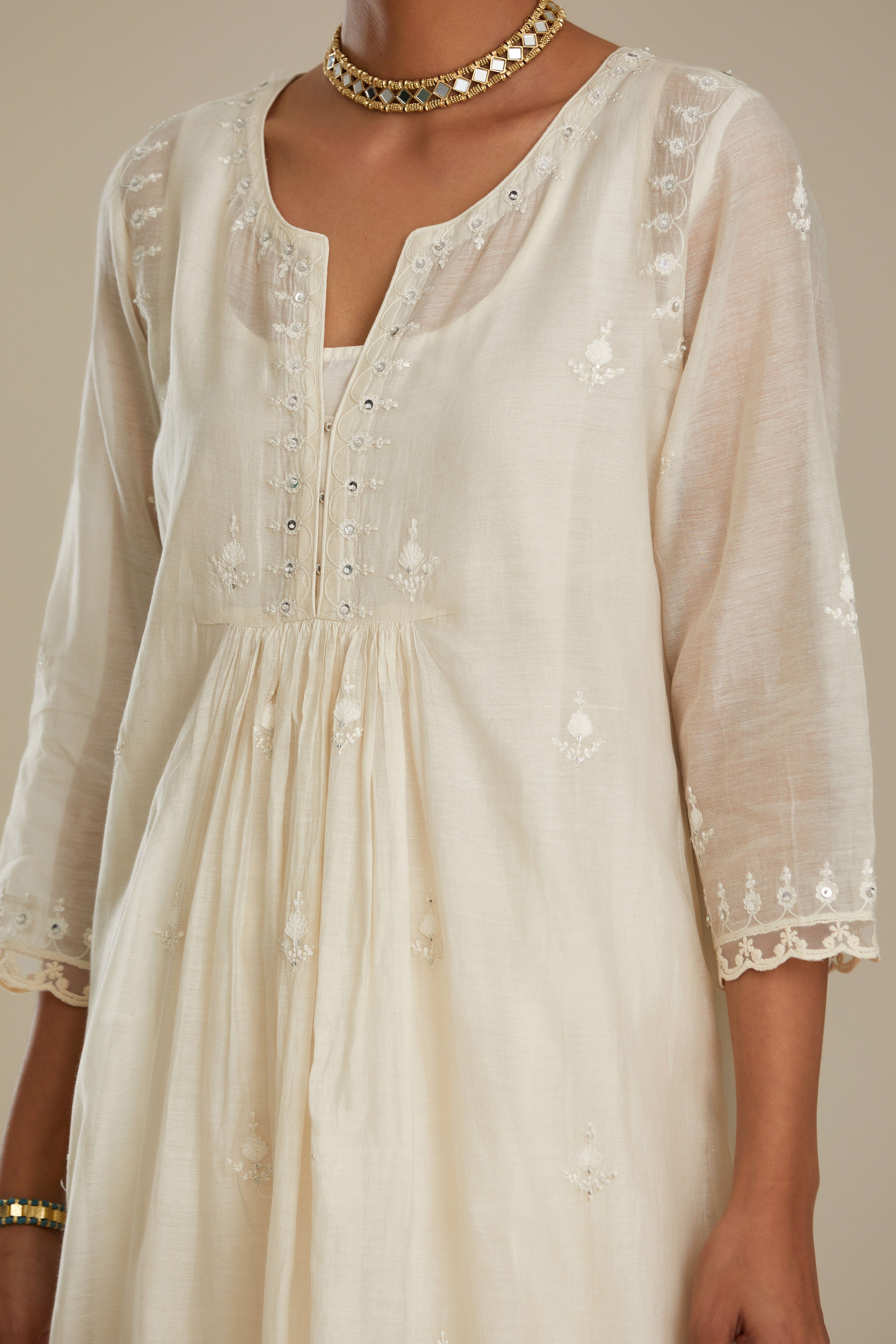 Cotton chanderi Kurta dress set with front gathers and all-over tonal thread embroidery, highlighted with sequins and beads.
