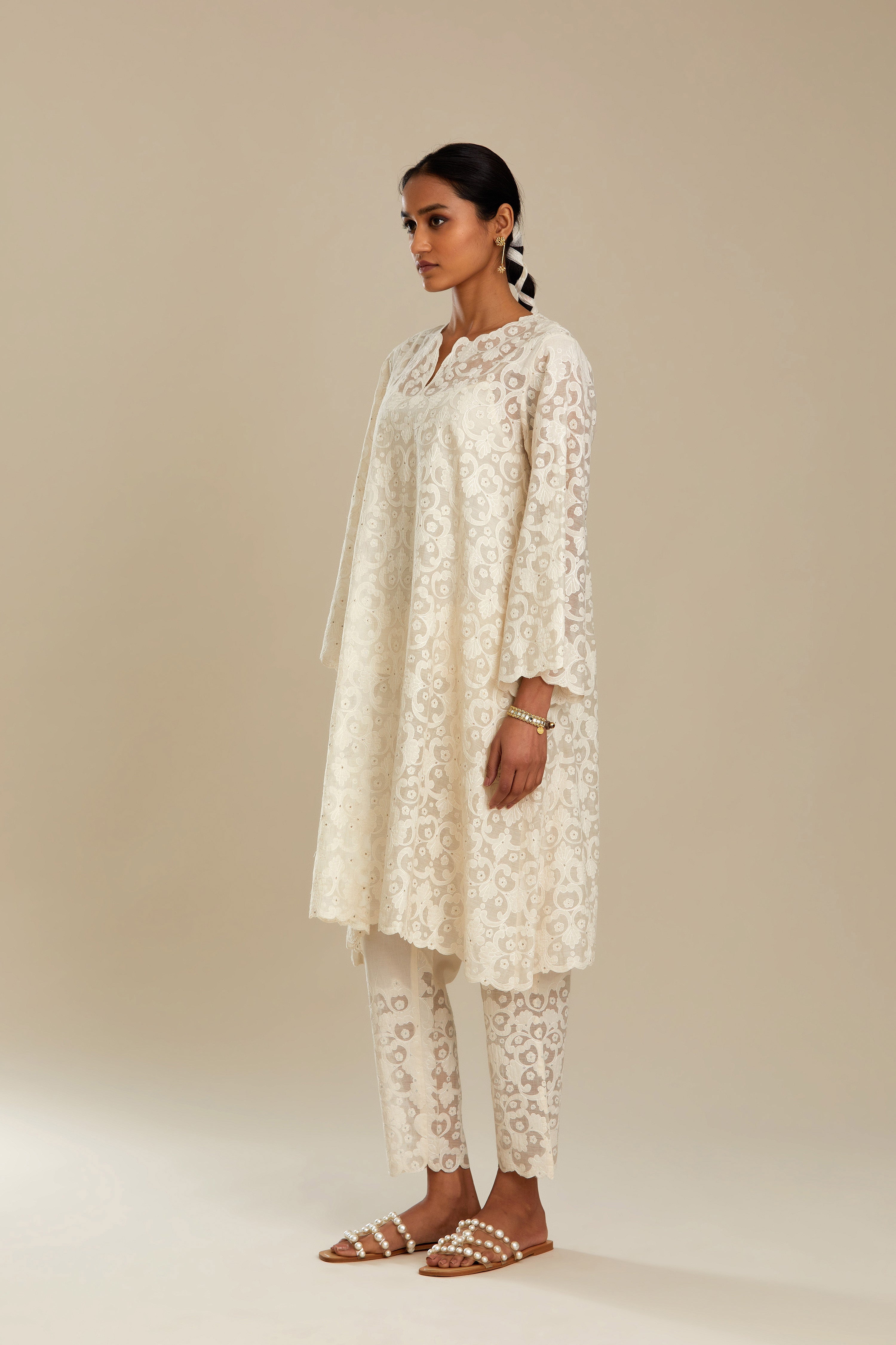 Off white short easy fit, straight hem kurta set with all-over trellis jaal appliqué, highlighted with sequins.