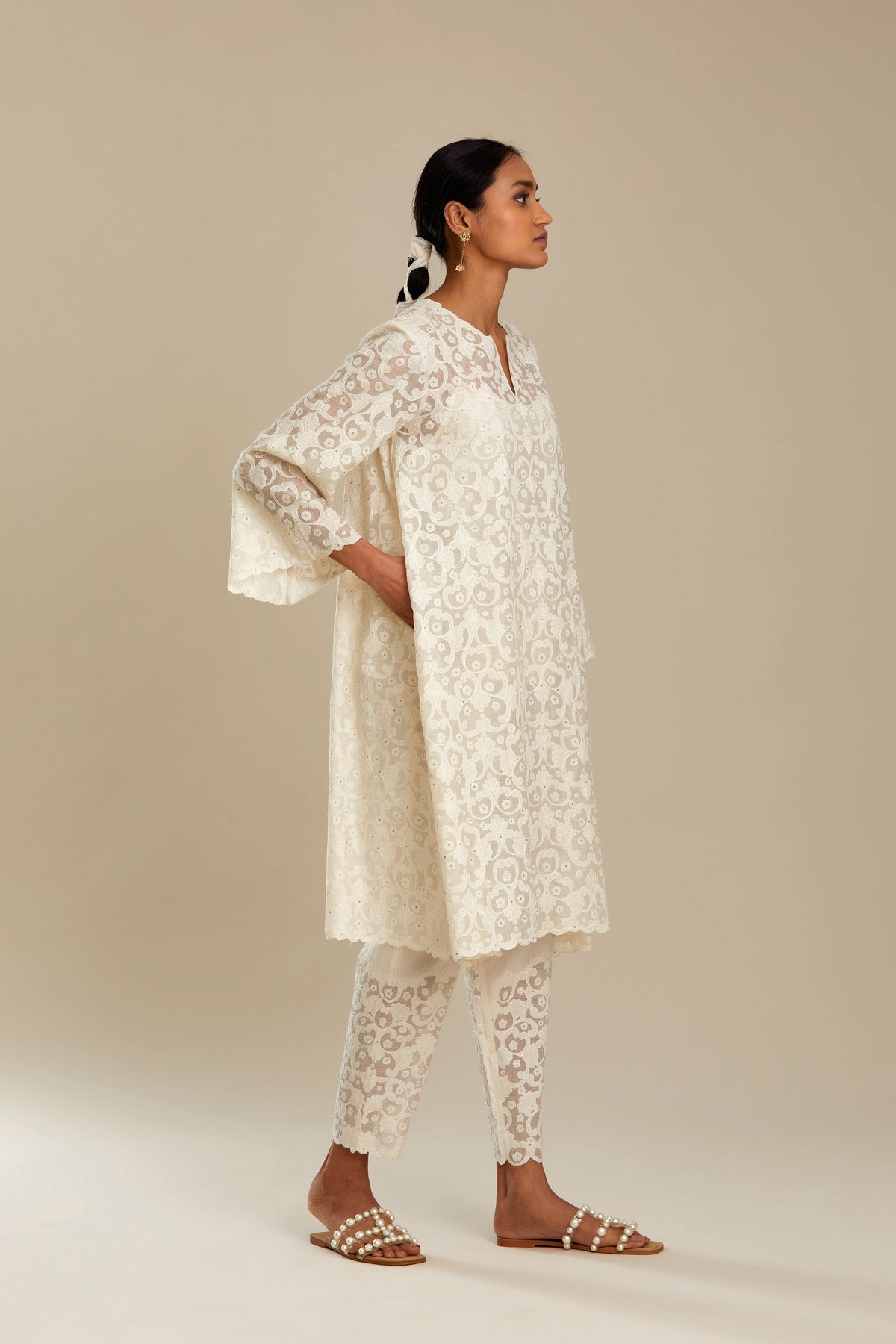 Off white short easy fit, straight hem kurta set with all-over trellis jaal appliqué, highlighted with sequins.