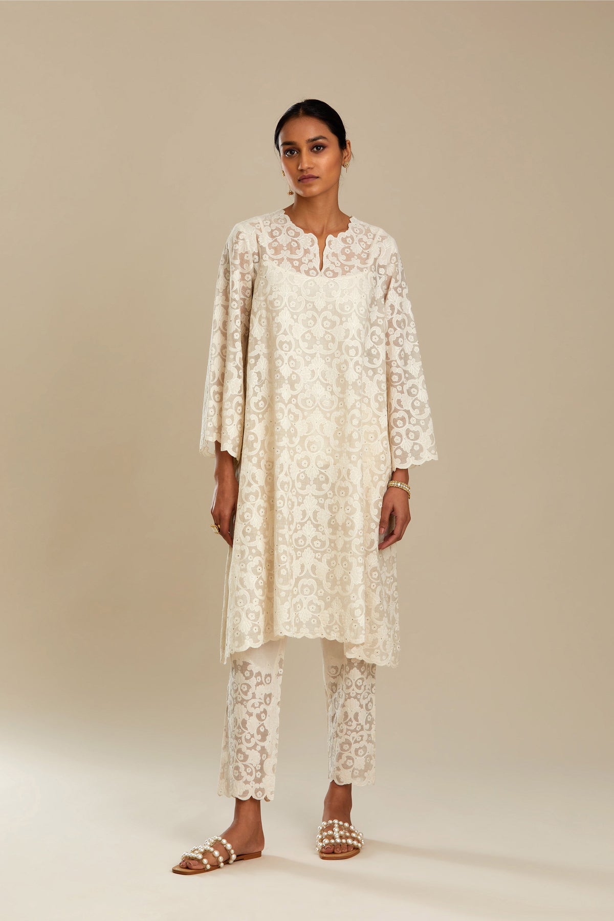 Off white short easy fit, straight hem kurta set with all-over trellis jaal appliqué, highlighted with sequins.