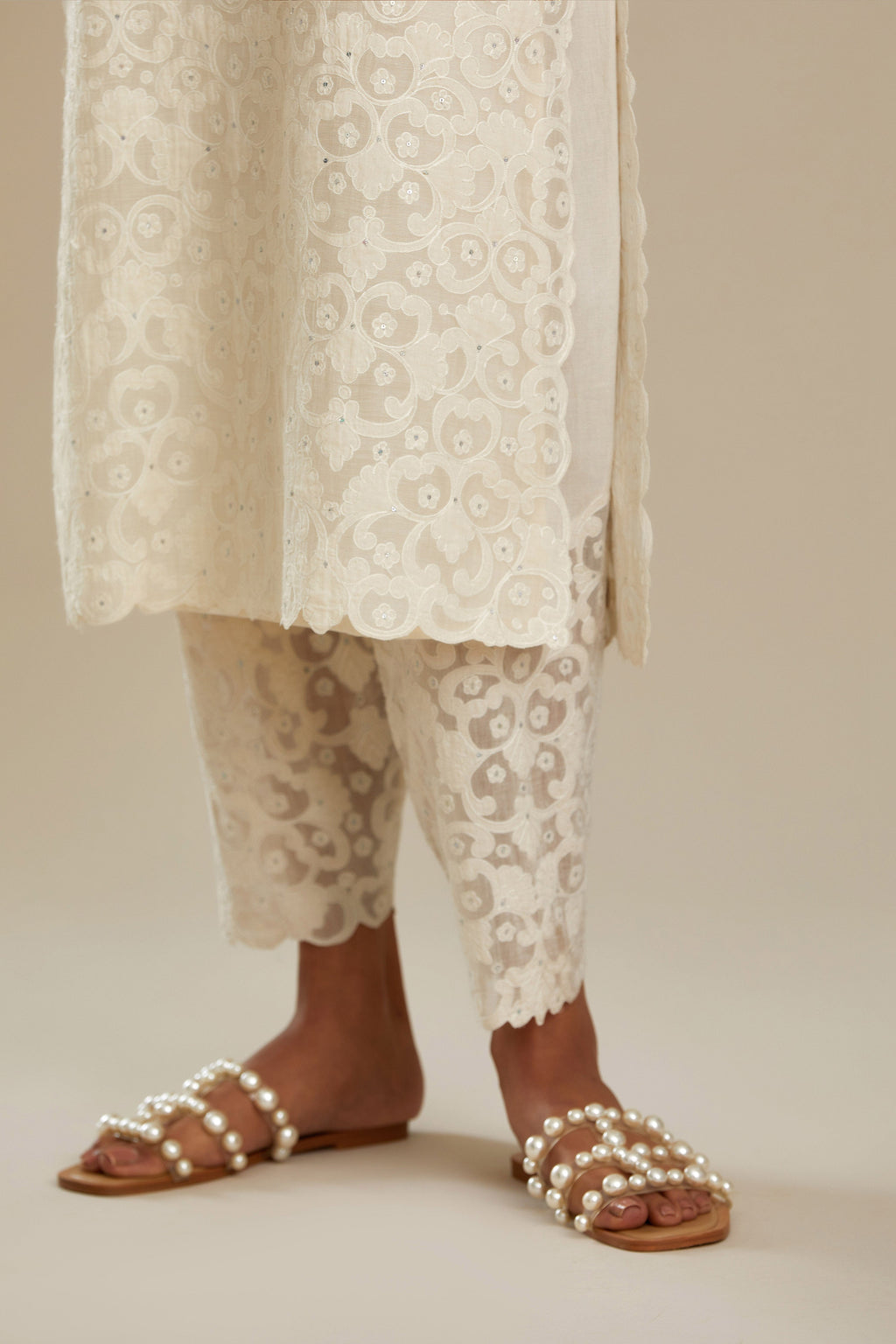 Off white straight kurta set with all-over cotton appliqué trellis jaal, highlighted with sequins.