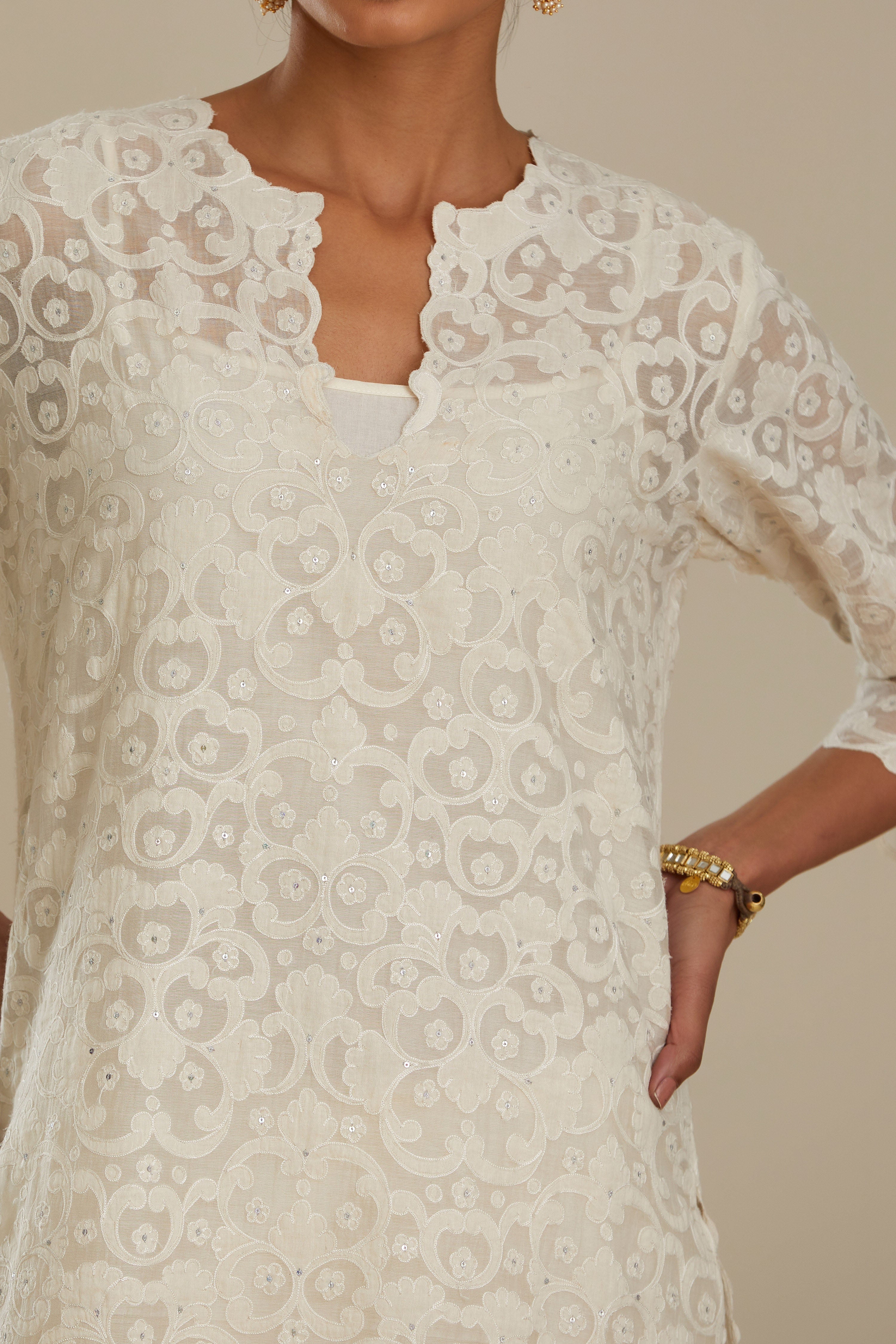 Off white straight kurta set with all-over cotton appliqué trellis jaal, highlighted with sequins.