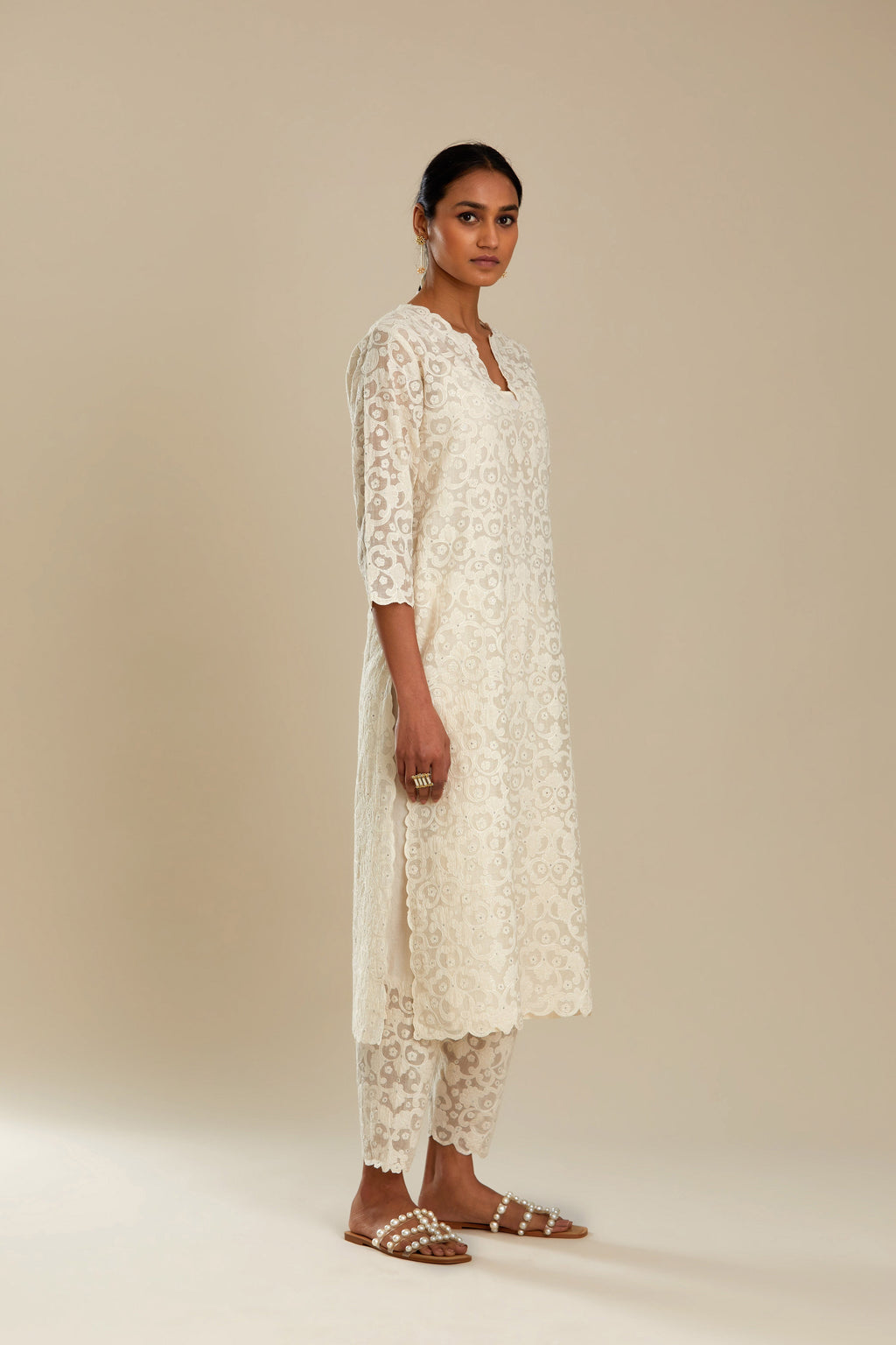Off white straight kurta set with all-over cotton appliqué trellis jaal, highlighted with sequins.