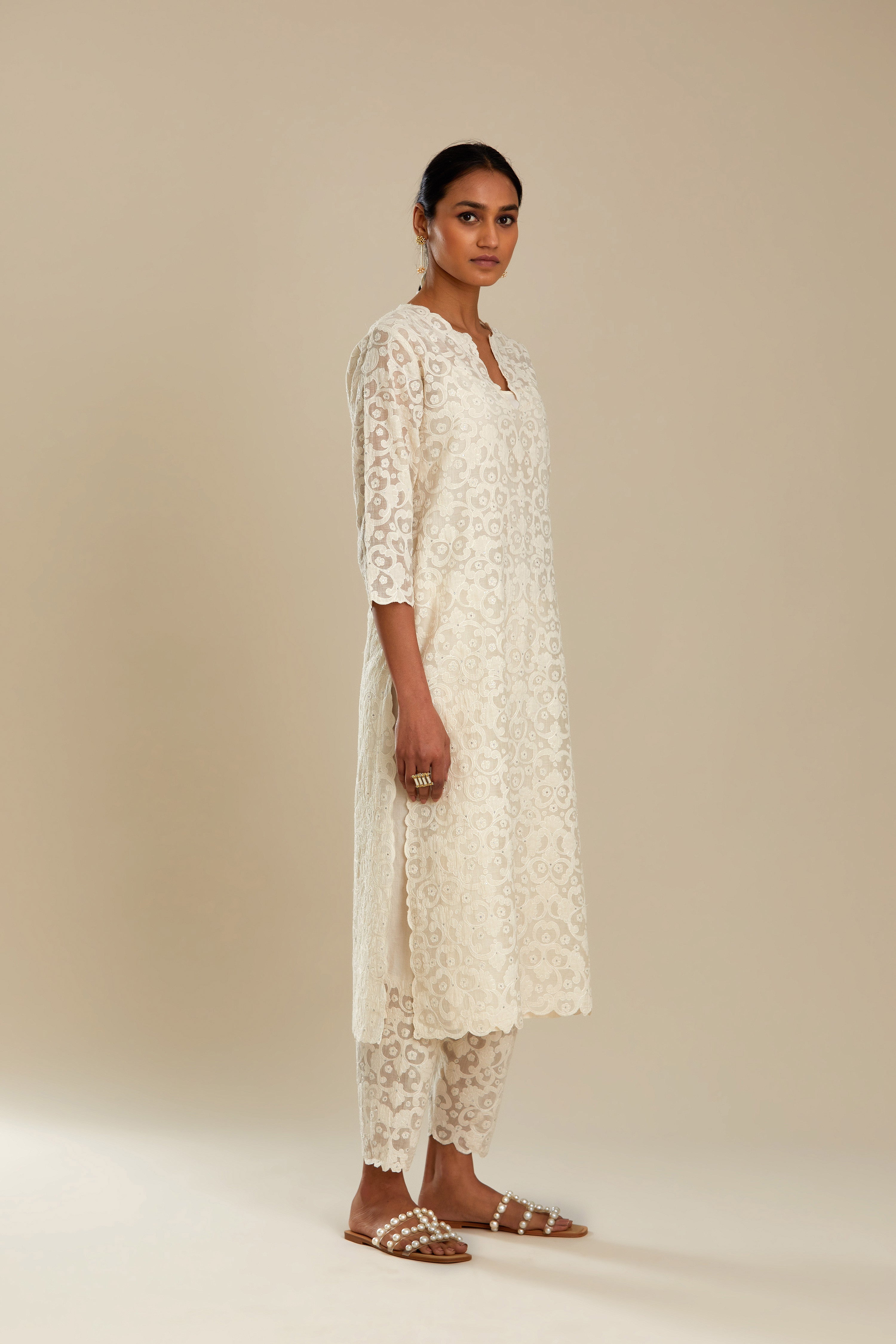 Off white straight kurta set with all-over cotton appliqué trellis jaal, highlighted with sequins.