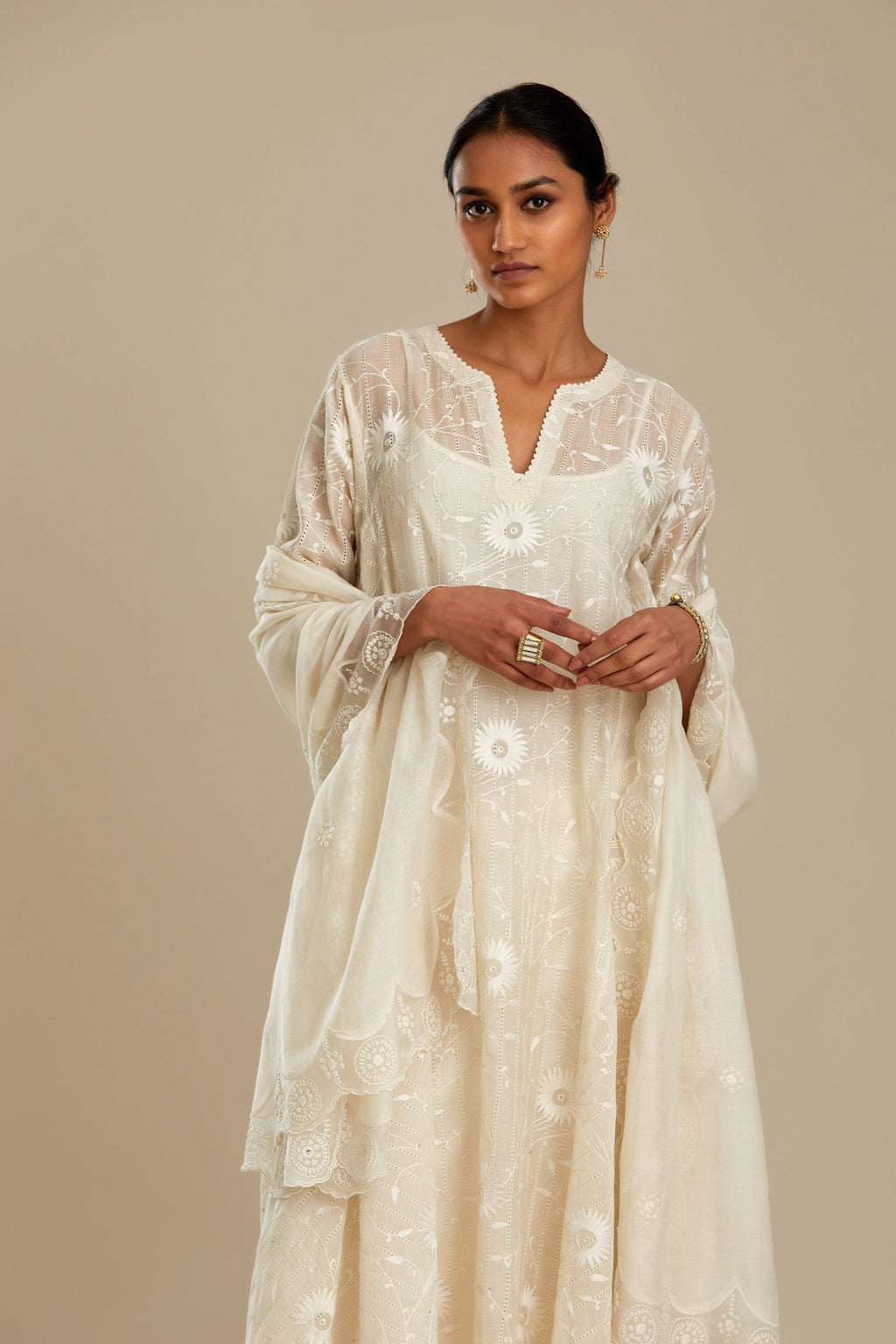 Off white cotton Chanderi kurta set with fagotting and an asymmetric hem, highlighted with silk thread floral jaal embroidery and sequins.