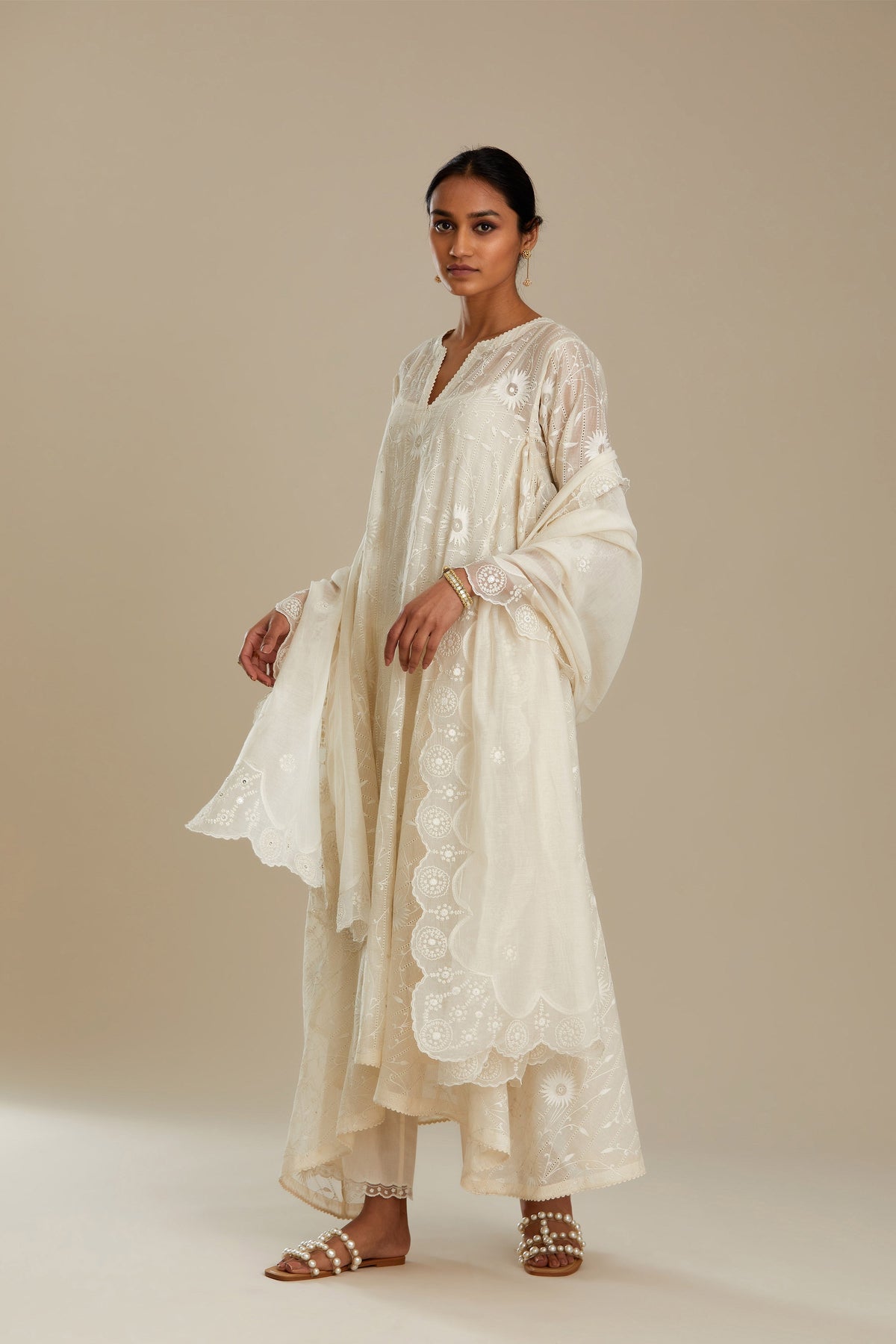 Off white cotton Chanderi kurta set with fagotting and an asymmetric hem, highlighted with silk thread floral jaal embroidery and sequins.