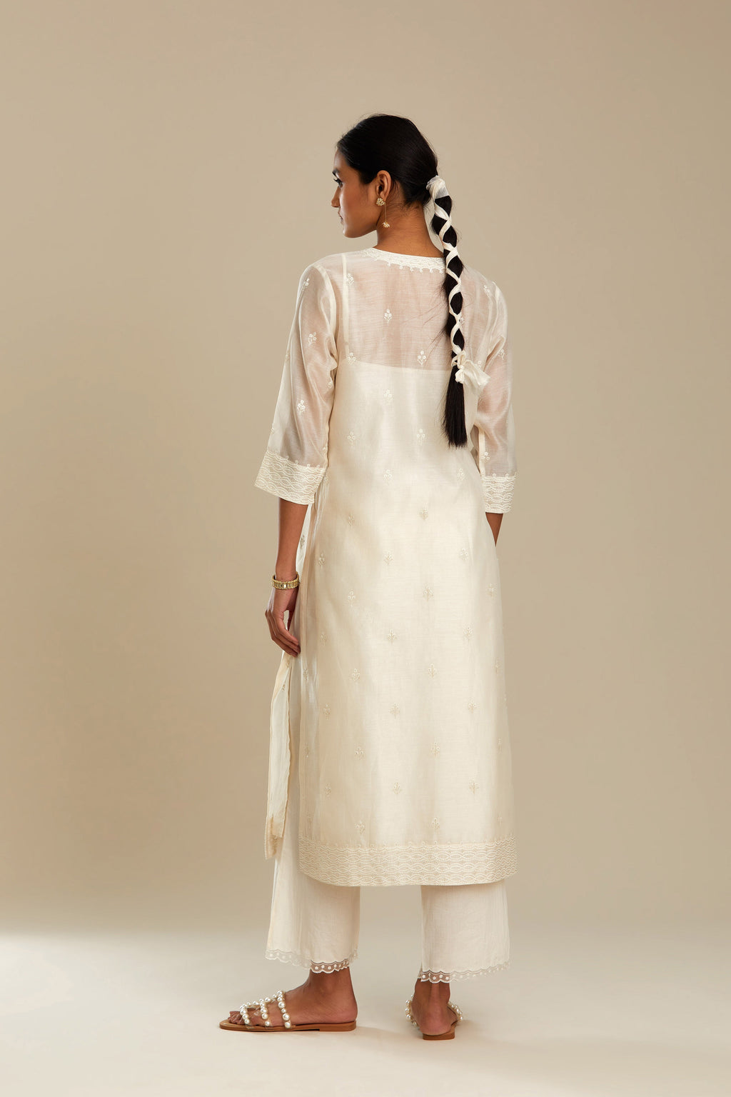 Silk chanderi straight kurta set, embroidered with tonal silk thread. Worn with a slip.