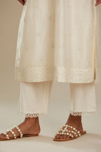 Silk chanderi straight kurta set, embroidered with tonal silk thread. Worn with a slip.