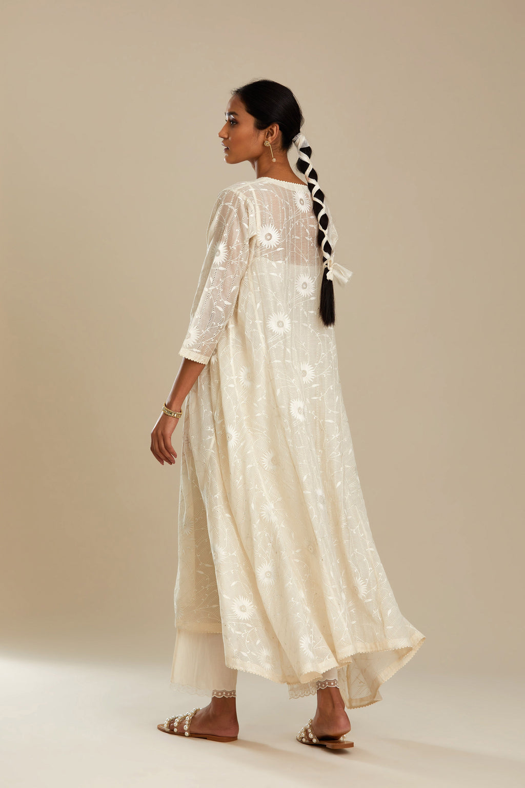 Off white cotton Chanderi kurta set with fagotting and an asymmetric hem, highlighted with silk thread floral jaal embroidery and sequins.