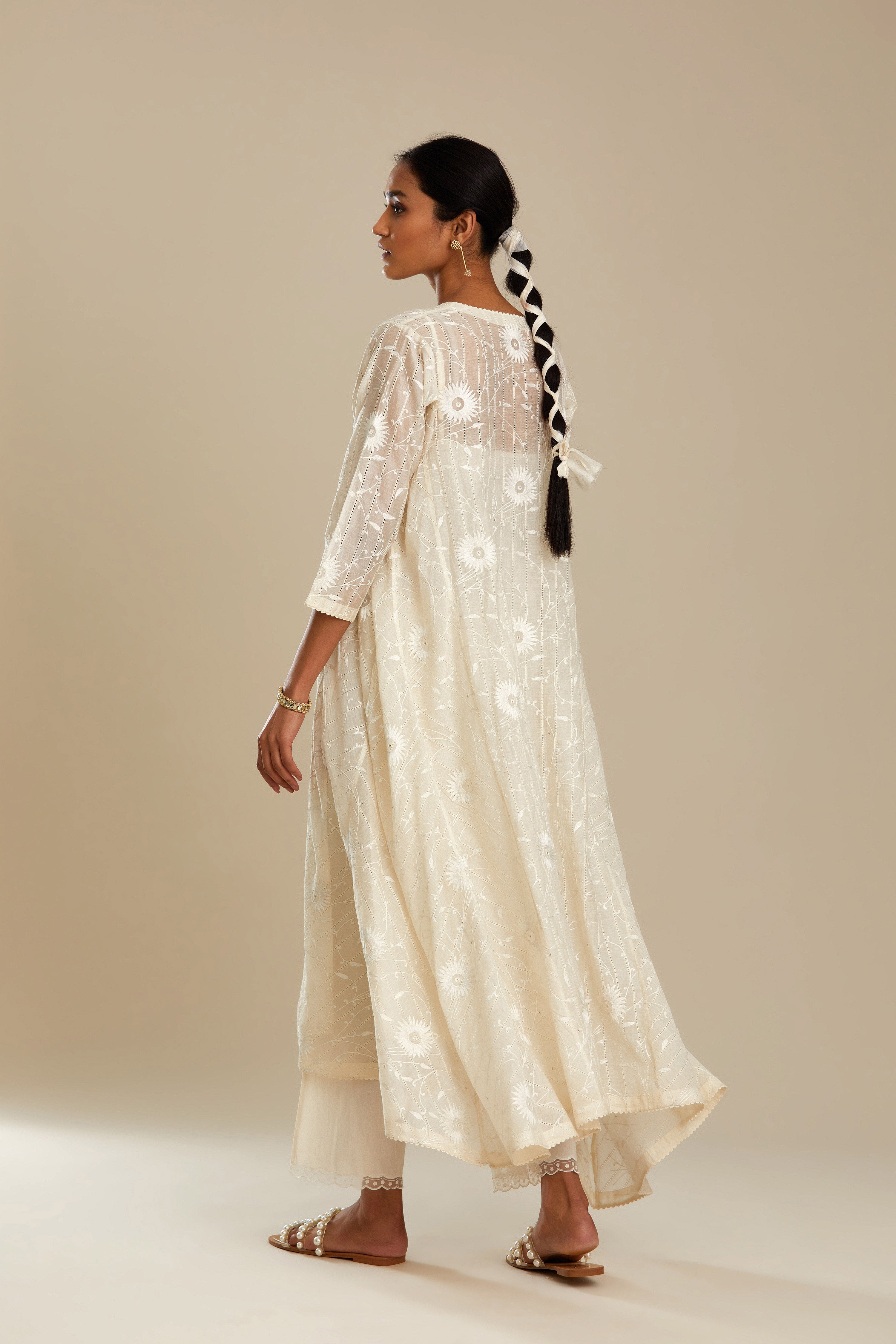 Off white cotton Chanderi kurta set with fagotting and an asymmetric hem, highlighted with silk thread floral jaal embroidery and sequins.