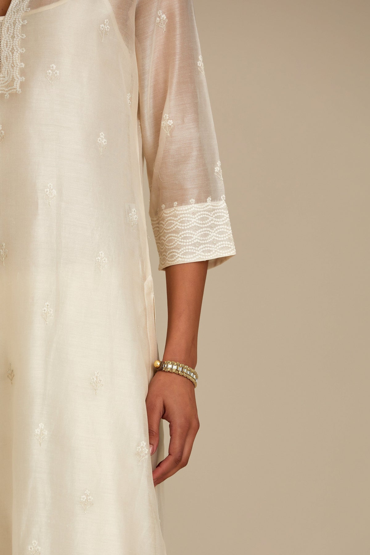 Silk chanderi straight kurta set, embroidered with tonal silk thread. Worn with a slip.