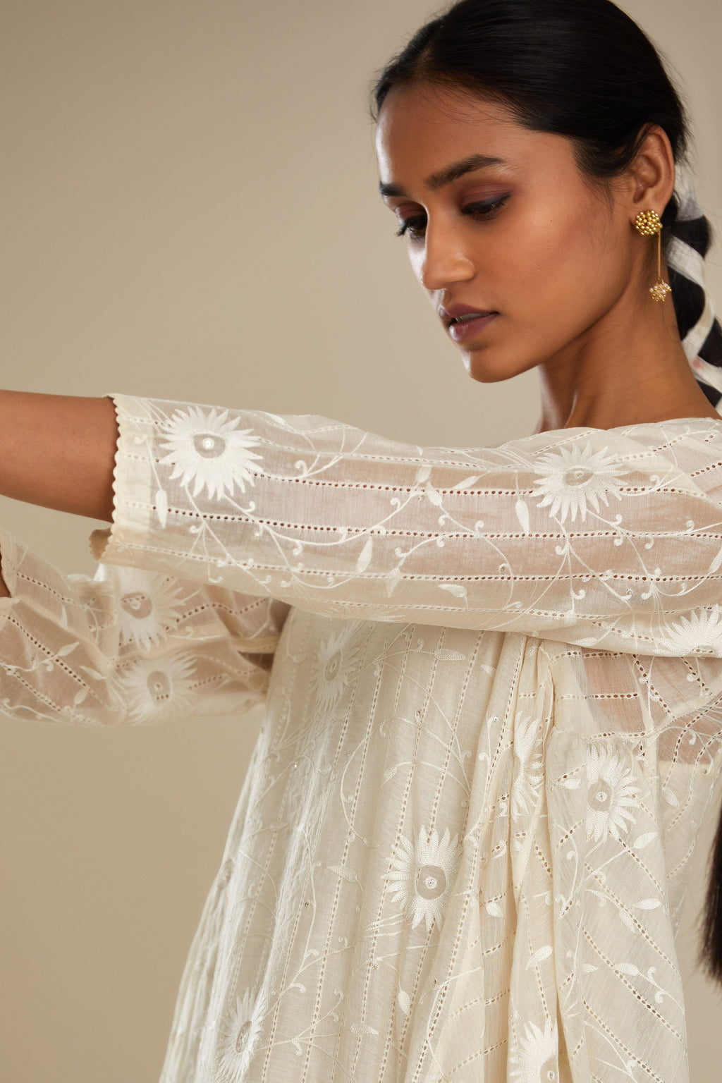 Off white cotton Chanderi kurta set with fagotting and an asymmetric hem, highlighted with silk thread floral jaal embroidery and sequins.