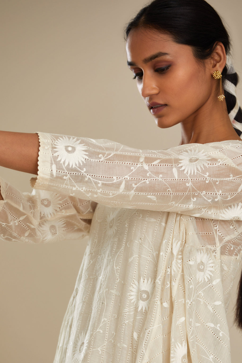 Off white cotton Chanderi kurta set with fagotting and an asymmetric hem, highlighted with silk thread floral jaal embroidery and sequins.