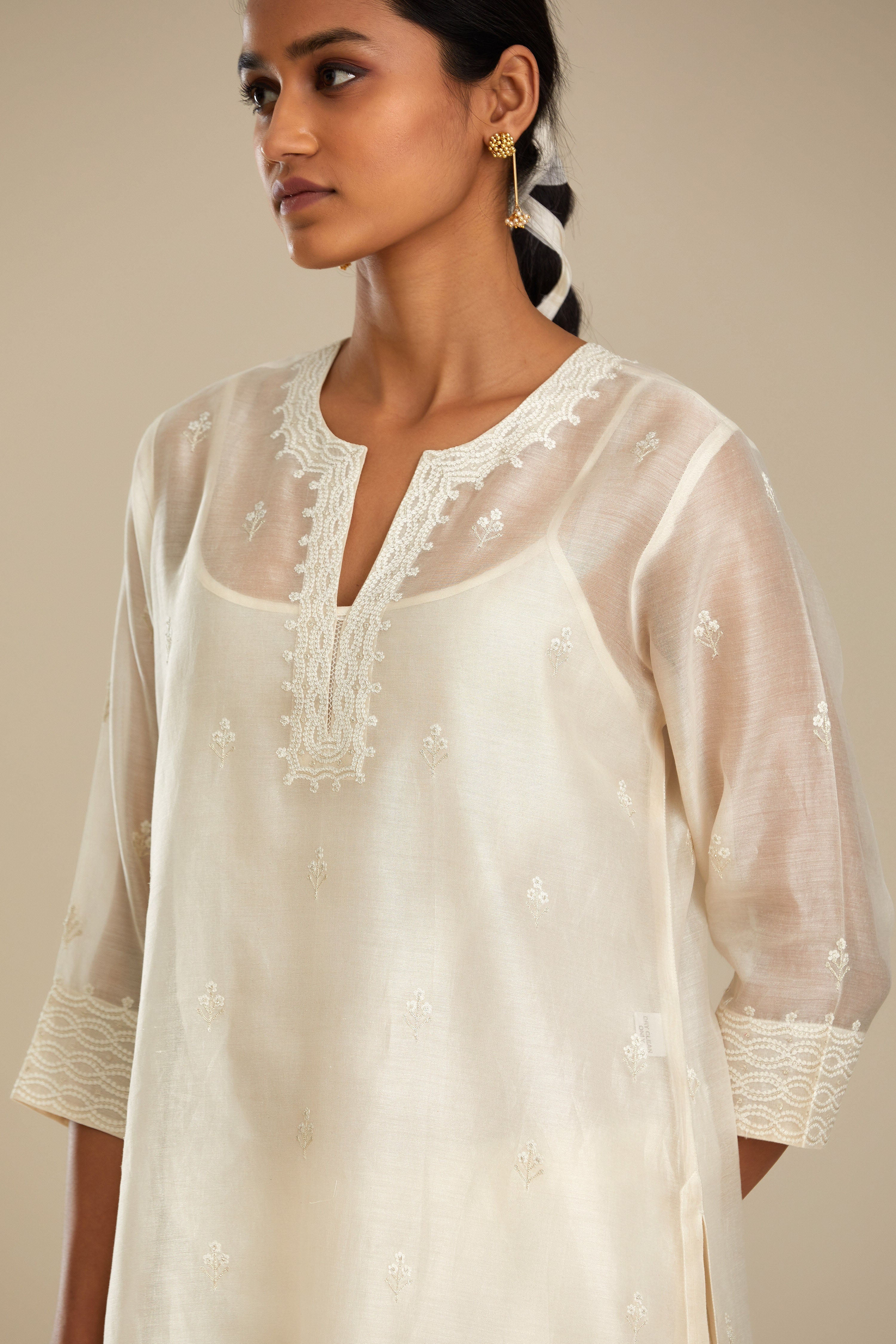 Silk chanderi straight kurta set, embroidered with tonal silk thread. Worn with a slip.