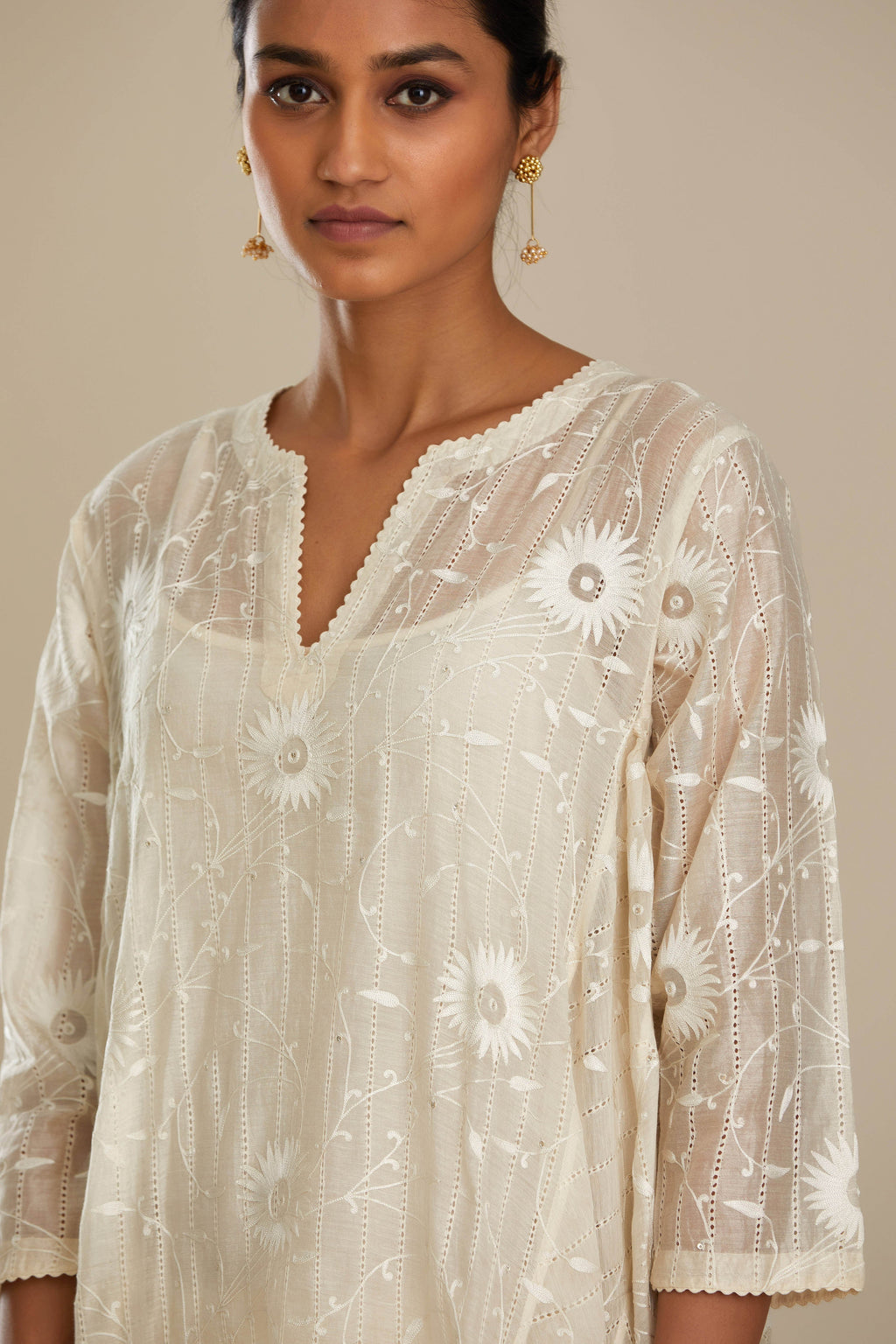 Off white cotton Chanderi kurta set with fagotting and an asymmetric hem, highlighted with silk thread floral jaal embroidery and sequins.