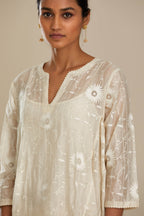 Off white cotton Chanderi kurta set with fagotting and an asymmetric hem, highlighted with silk thread floral jaal embroidery and sequins.