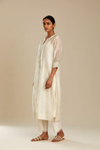 Silk chanderi straight kurta set, embroidered with tonal silk thread. Worn with a slip.