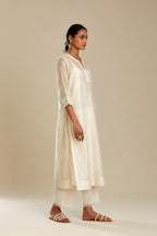Silk chanderi straight kurta set, embroidered with tonal silk thread. Worn with a slip.