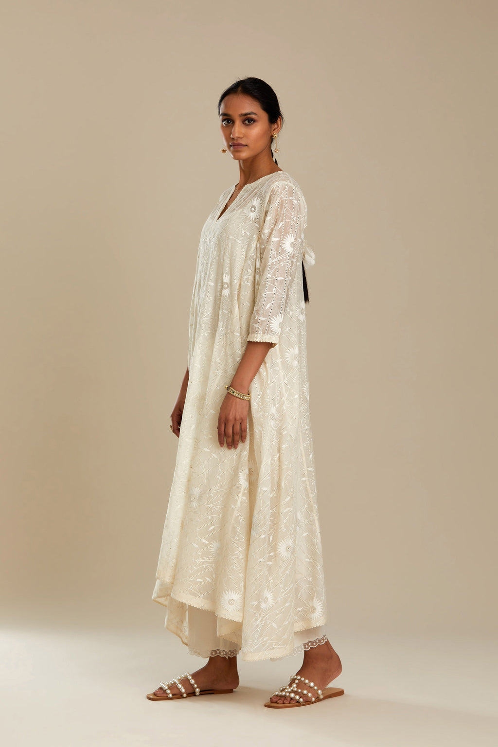 Off white cotton Chanderi kurta set with fagotting and an asymmetric hem, highlighted with silk thread floral jaal embroidery and sequins.