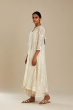 Off white cotton Chanderi kurta set with fagotting and an asymmetric hem, highlighted with silk thread floral jaal embroidery and sequins.