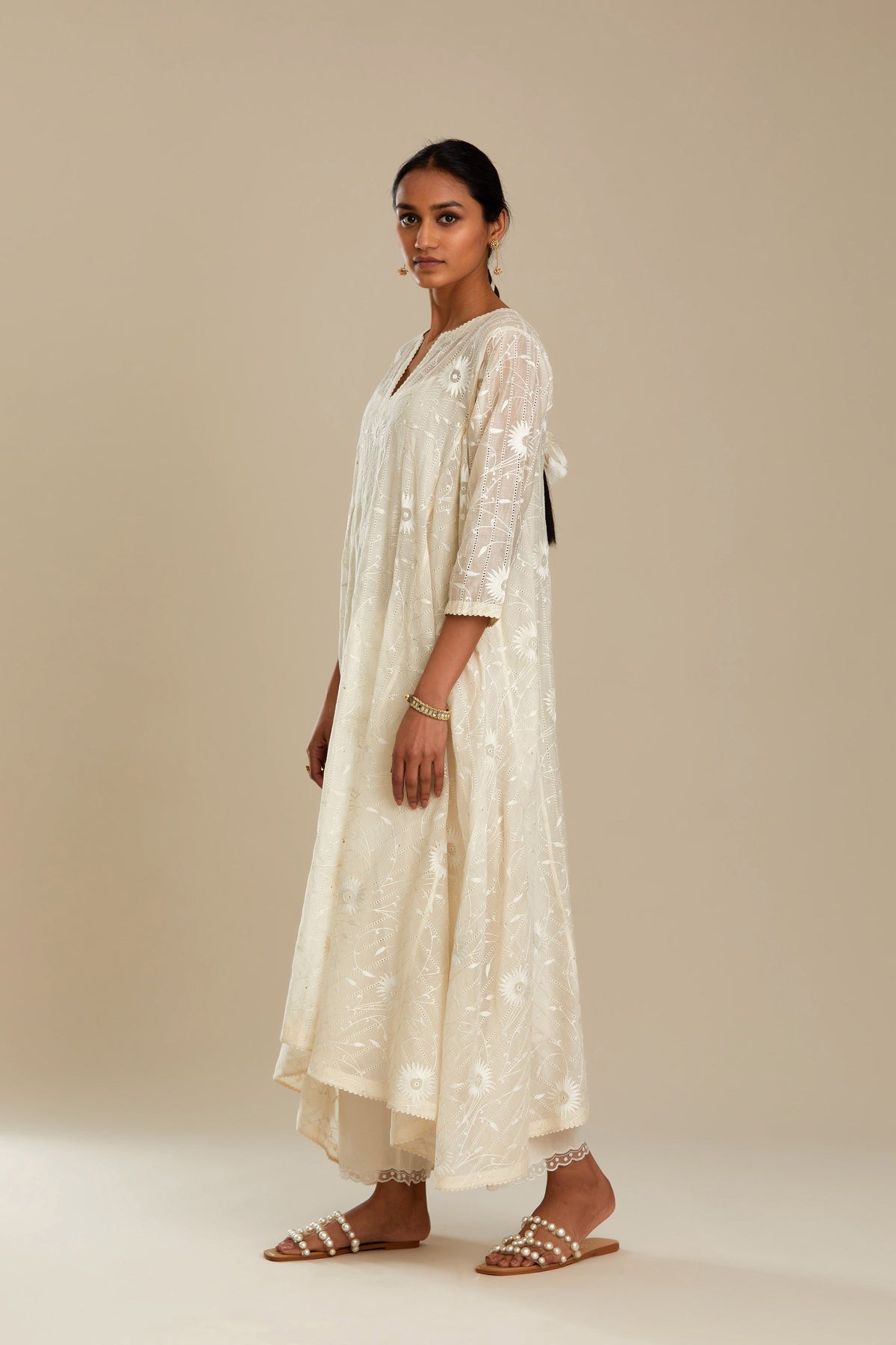 Off white cotton Chanderi kurta set with fagotting and an asymmetric hem, highlighted with silk thread floral jaal embroidery and sequins.