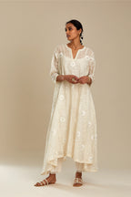 Off white cotton Chanderi kurta set with fagotting and an asymmetric hem, highlighted with silk thread floral jaal embroidery and sequins.