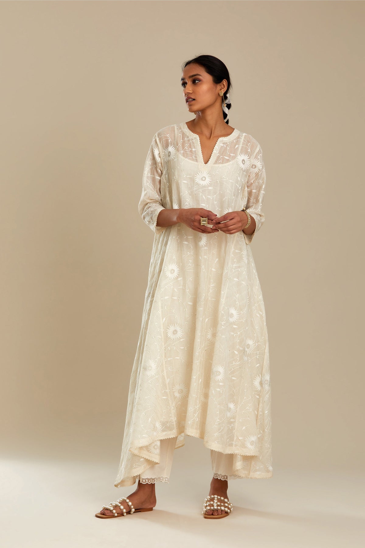 Off white cotton Chanderi kurta set with fagotting and an asymmetric hem, highlighted with silk thread floral jaal embroidery and sequins.