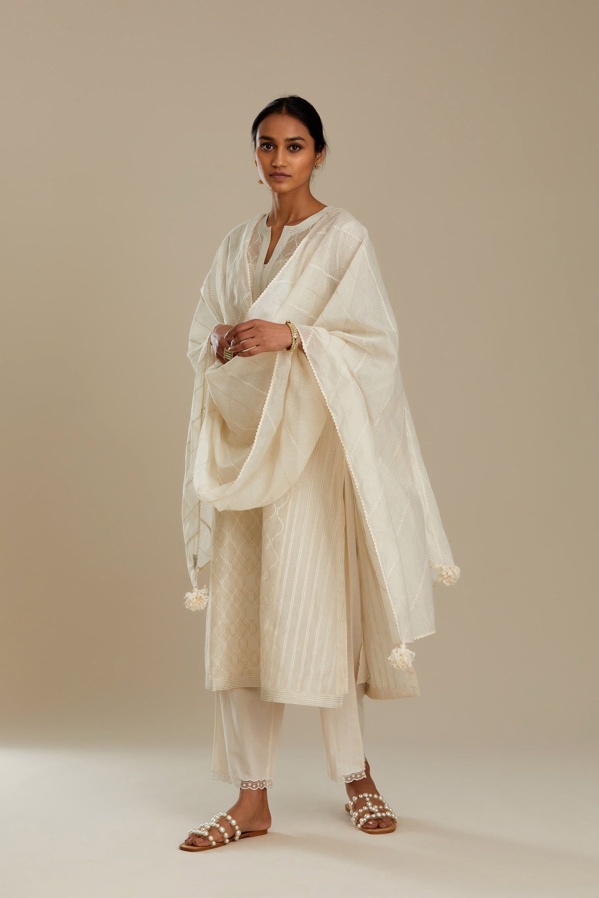 Off white silk chanderi straight kurta set with all over thread and zari jaal embroidery at central panel and striped trellis detail at kalis.