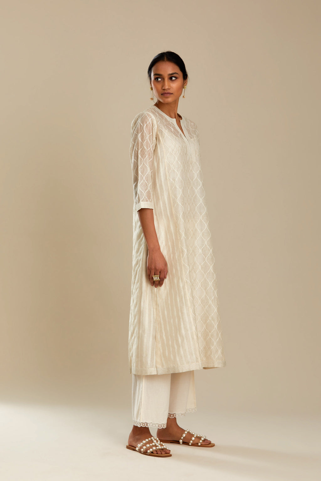 Off white silk chanderi straight kurta set with all over thread and zari jaal embroidery at central panel and striped trellis detail at kalis.