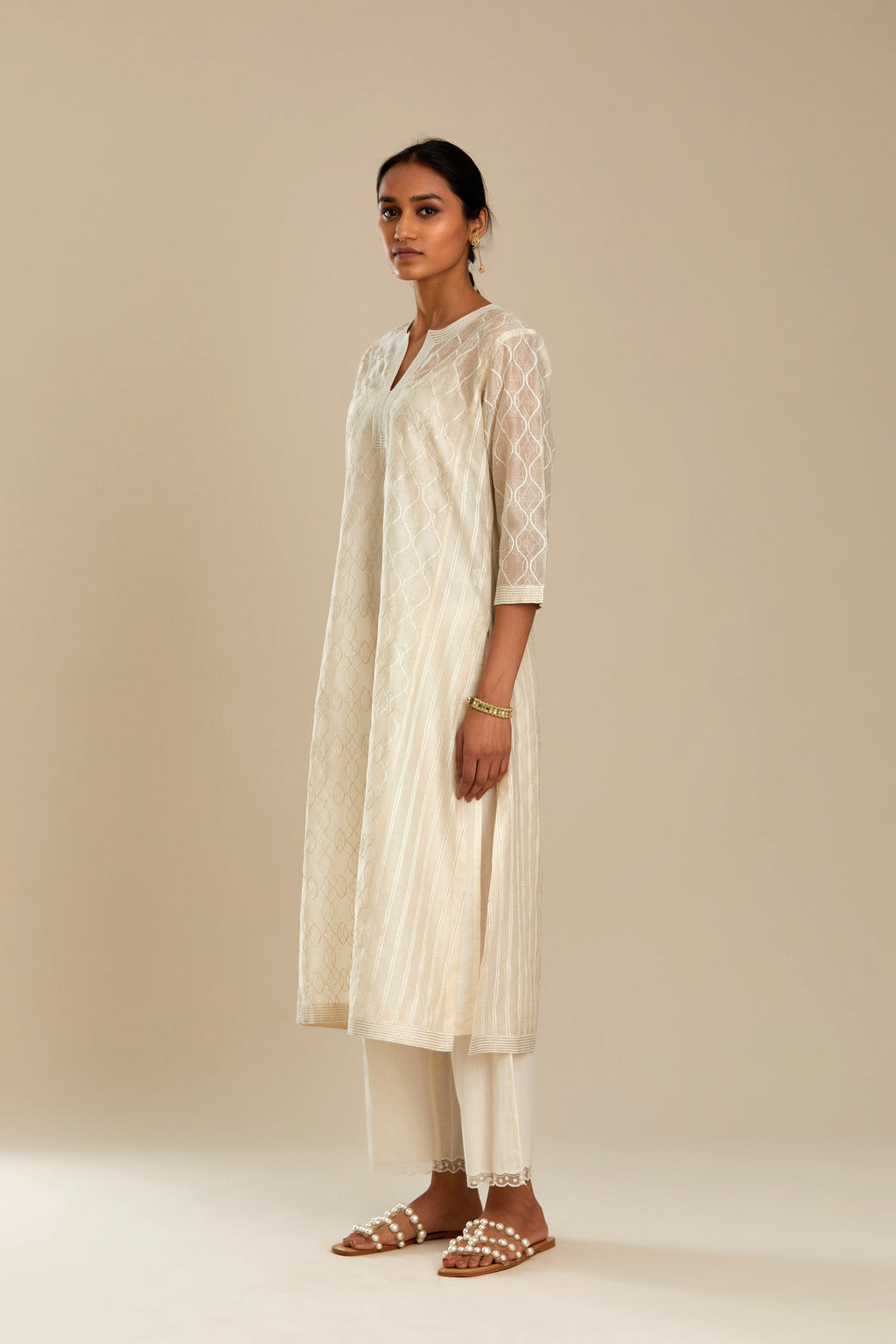 Off white silk chanderi straight kurta set with all over thread and zari jaal embroidery at central panel and striped trellis detail at kalis.