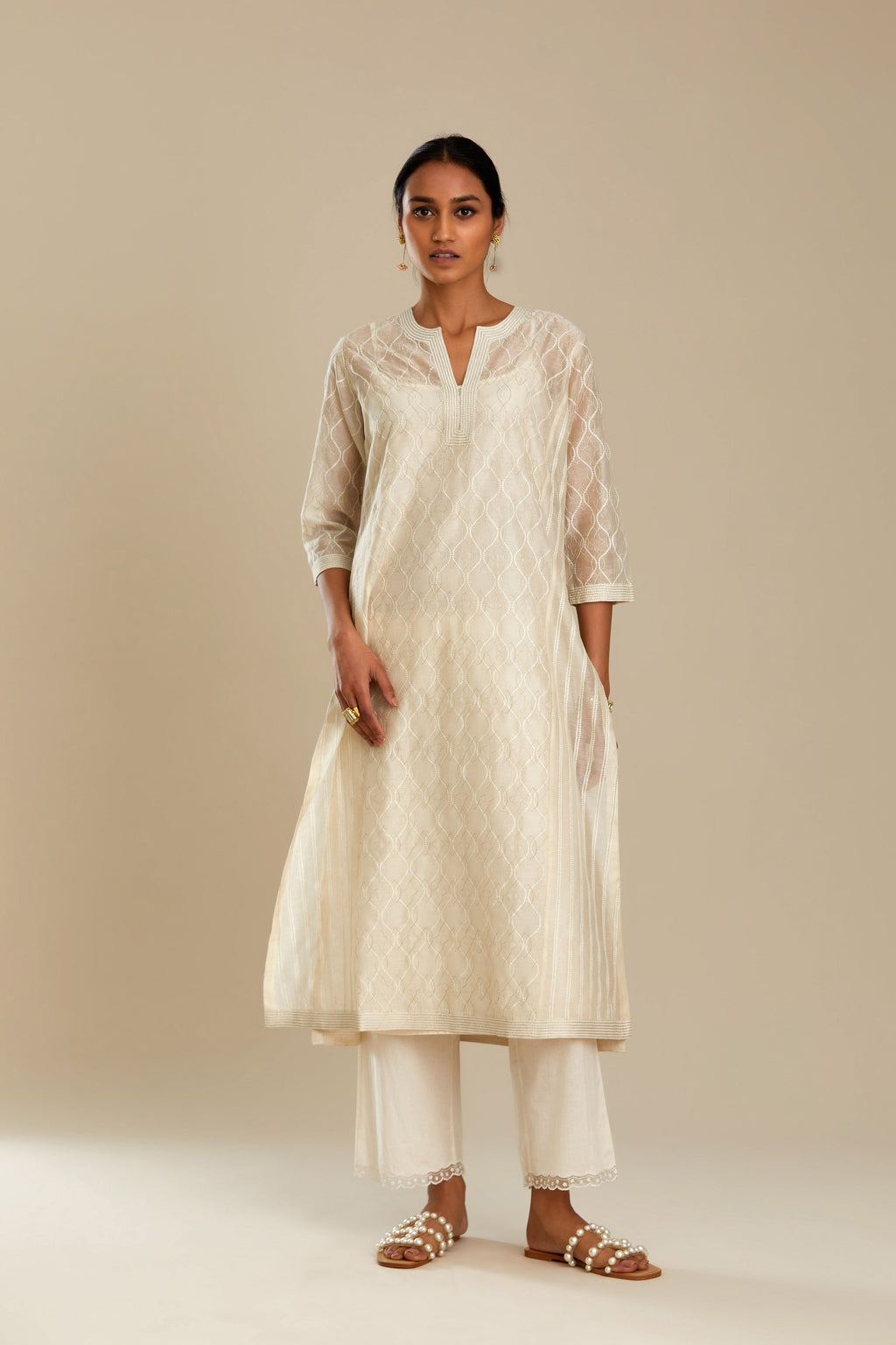 Off white silk chanderi straight kurta set with all over thread and zari jaal embroidery at central panel and striped trellis detail at kalis.