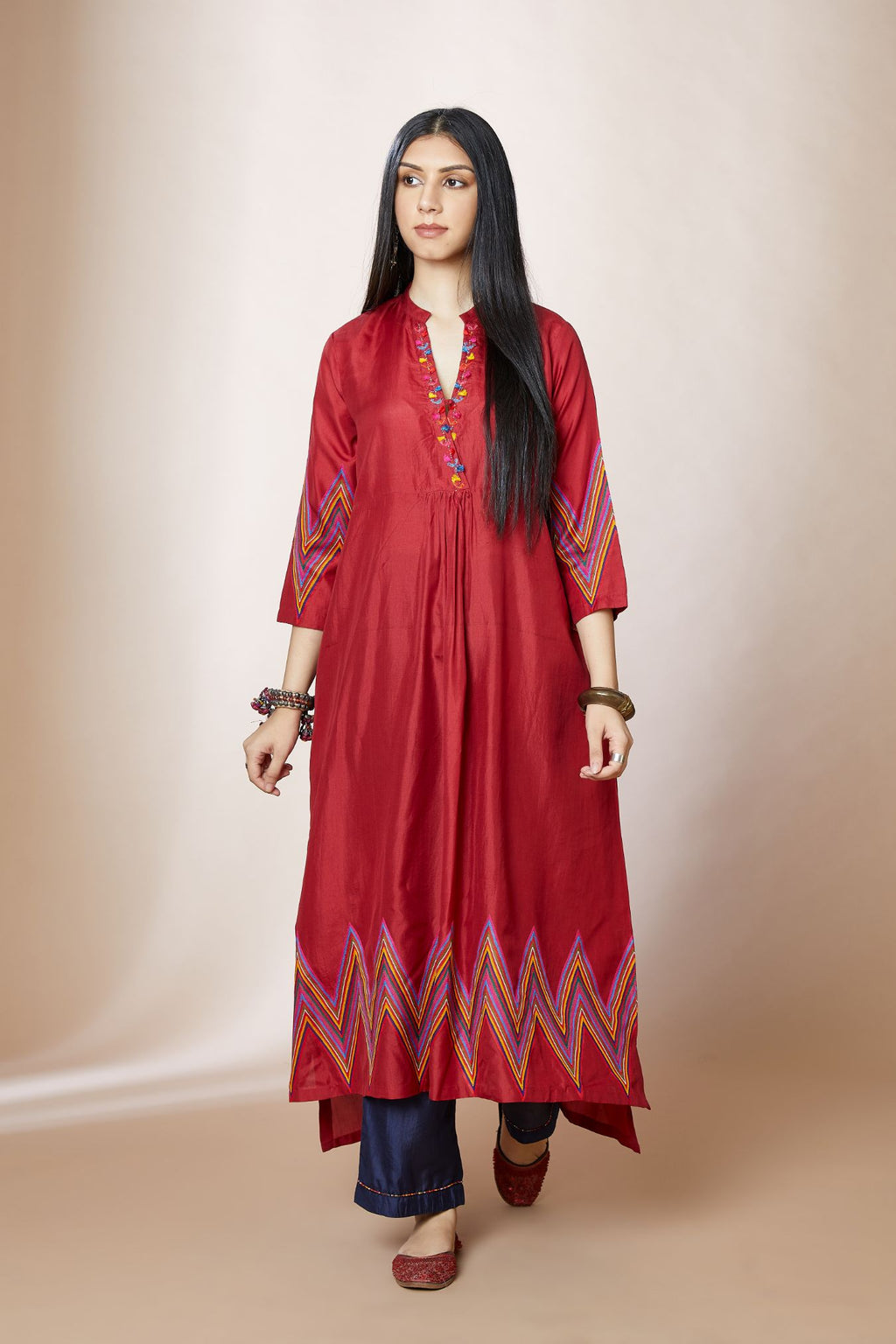 Maroon silk A-line kurta set with multi coloured chevron embroidery and overlapped neckline