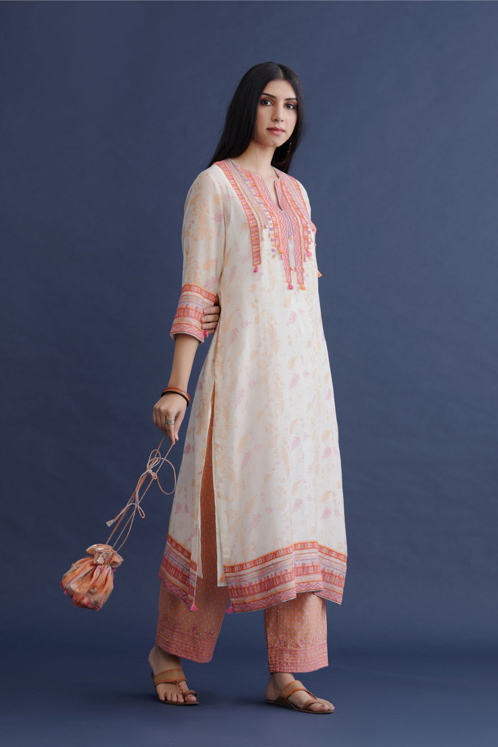 Off white hand block printed straight kurta set with pink and orange thread embroidery and delicate beaded hand work at neck, sleeve and hem