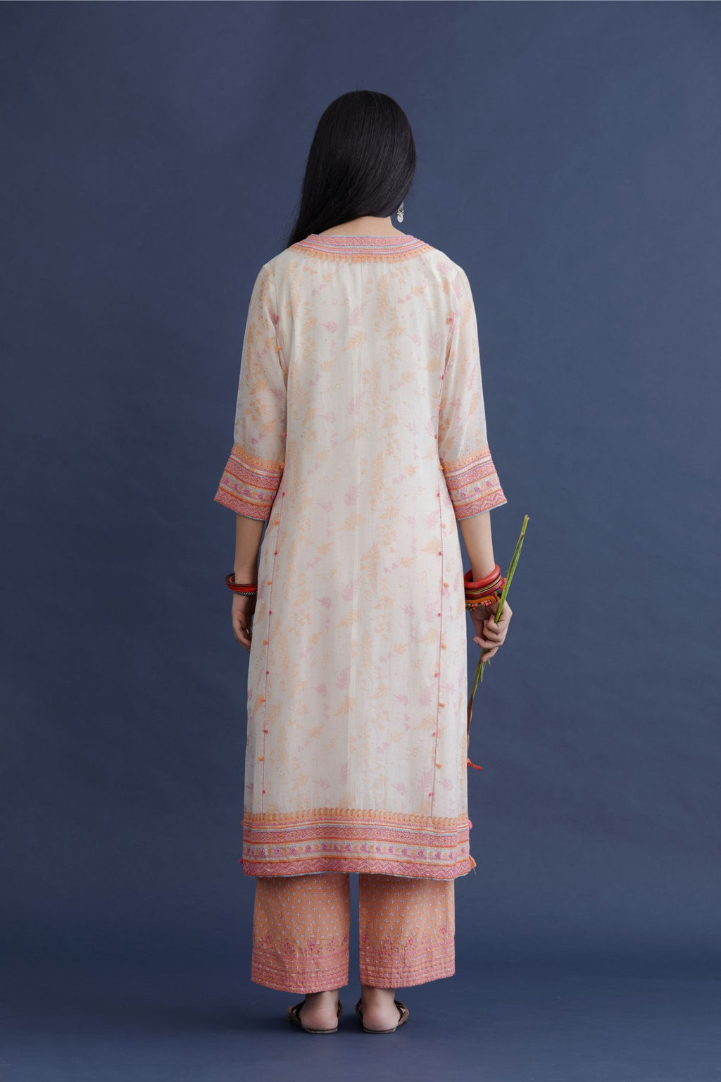 Off white straight kurta set with heavy embroidered button placket neckline and delicate bead and tassel embroidery at side panel joint seams