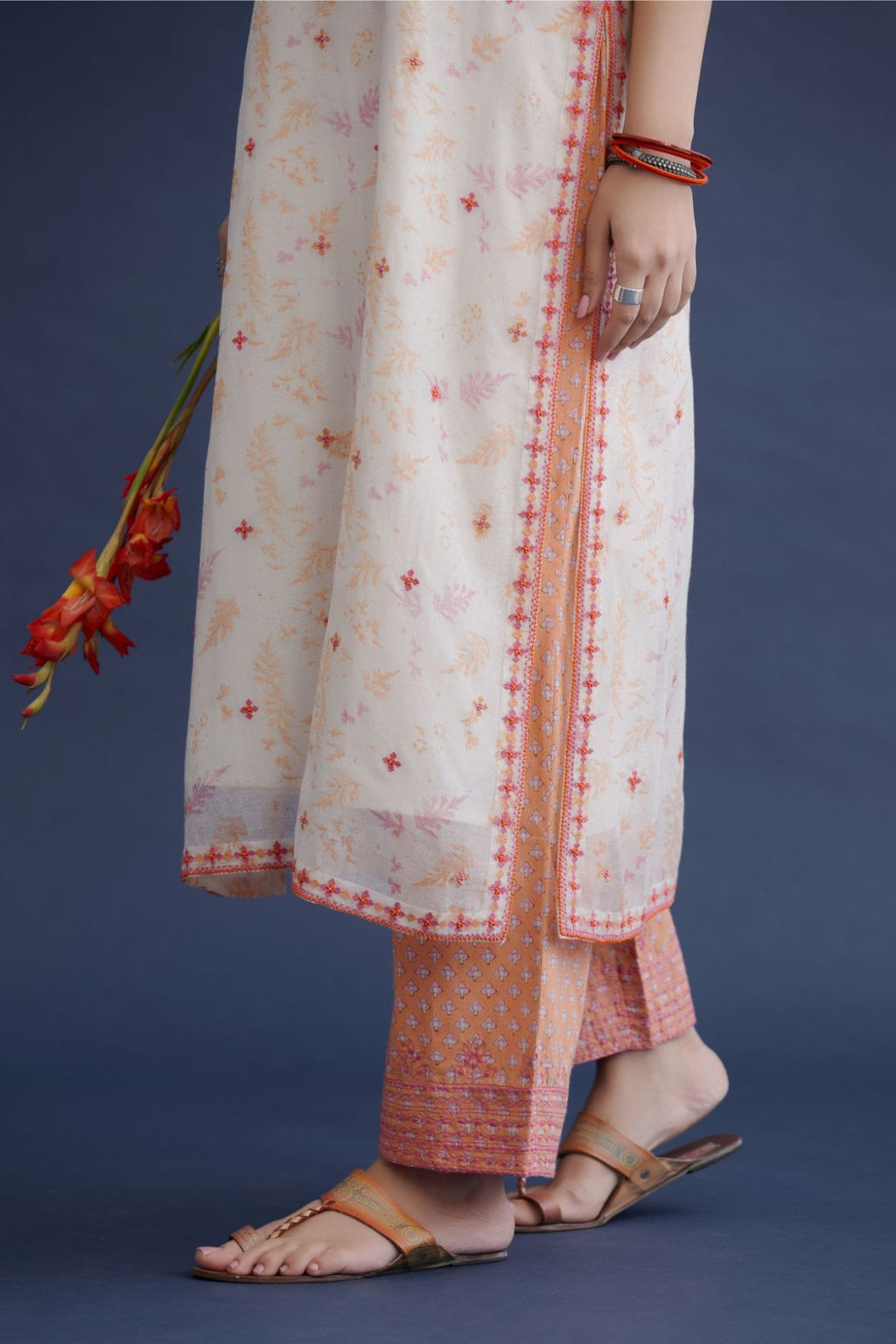 Off white hand block printed straight kurta set with all-over pink and orange thread embroidery and delicate beaded hand work