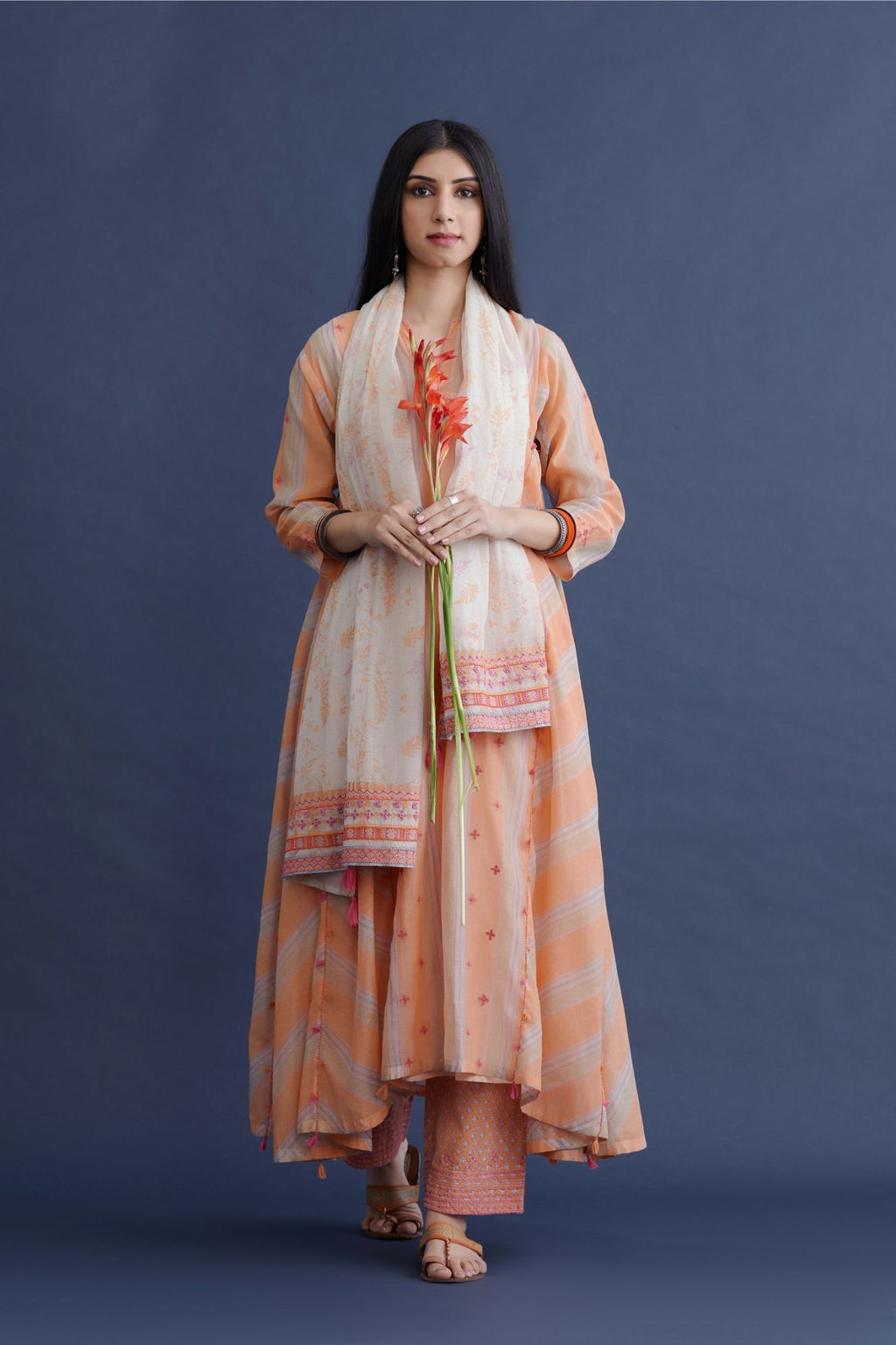 Orange beige and soft blue hand block printed striped cotton Chanderi kurta set with asymmetric hem, highlighted with delicate bead and tassel embroidery