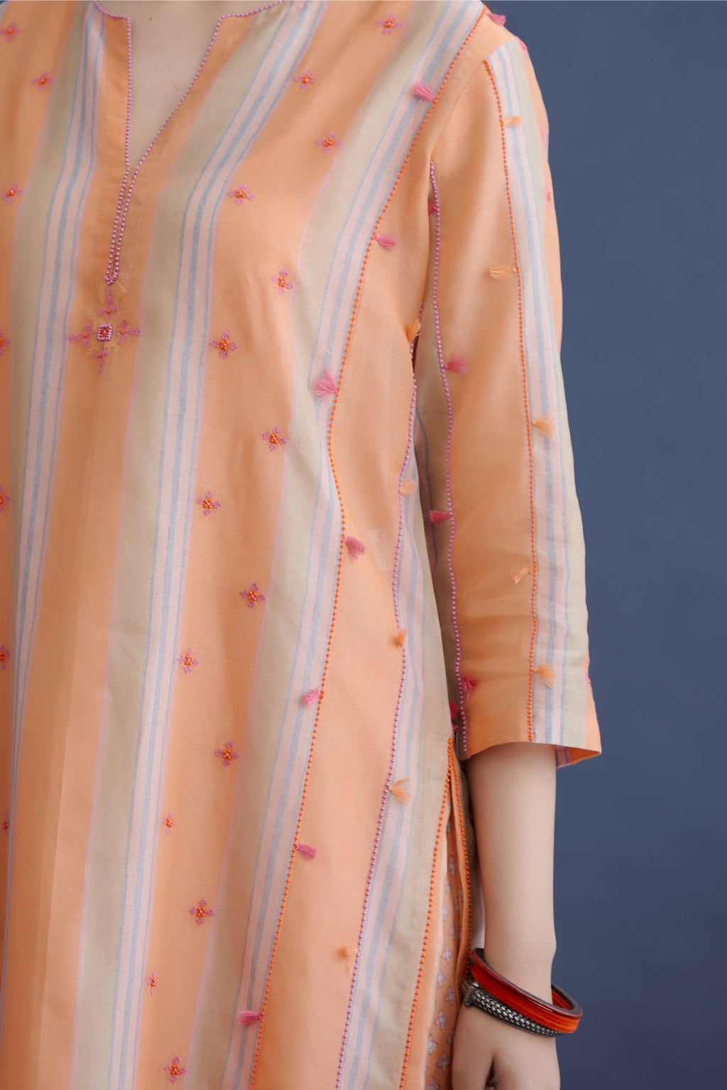 Orange beige and soft blue hand block printed striped cotton Chanderi straight kurta set, highlighted with delicate bead and tassel embroidery