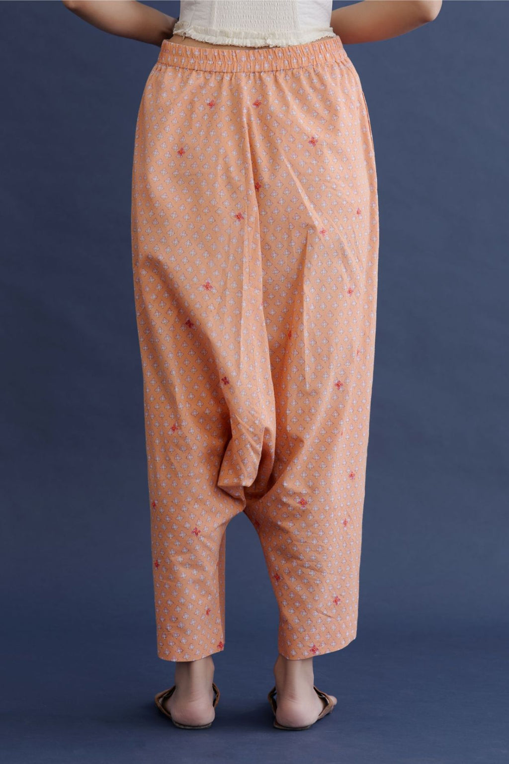 Hand block printed cotton low pants with all-over contrast thread embroidery highlighted with beaded hand work.