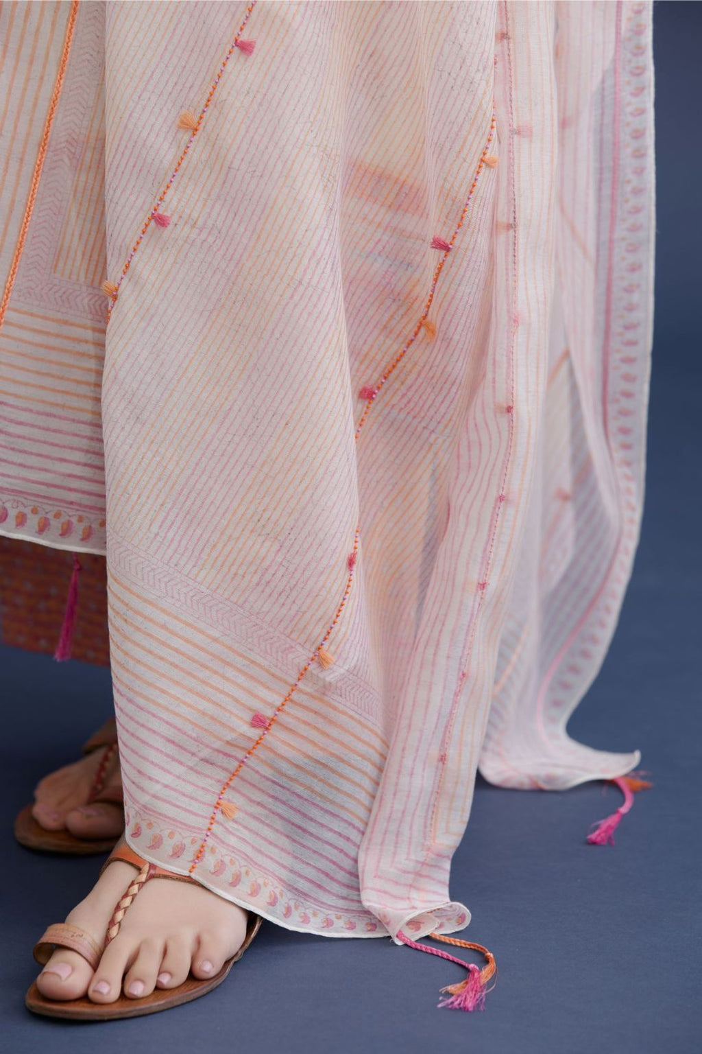 Off white cotton Chanderi dupatta with all over pink and orange hand block print, highlighted with bead and thread tassel embroidery